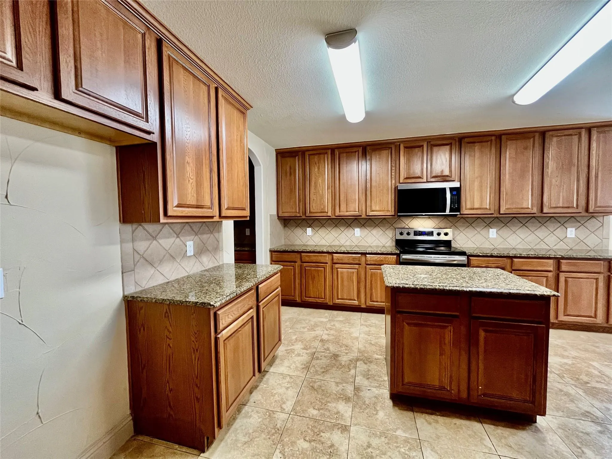 Kitchen with wood cabinets, countertops, and appliances
