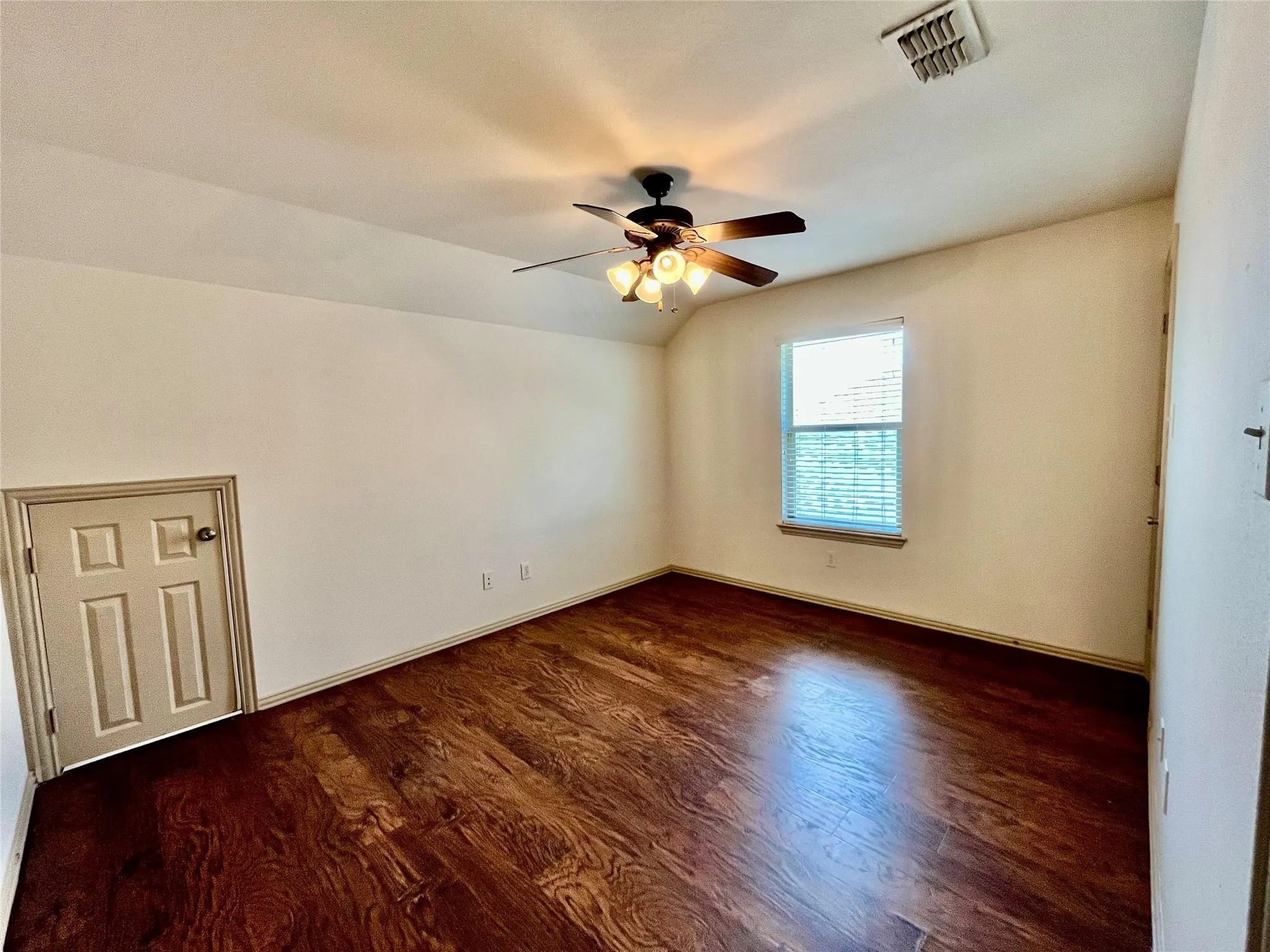 Bedroom with wood flooring, ceiling fan, window, and closet