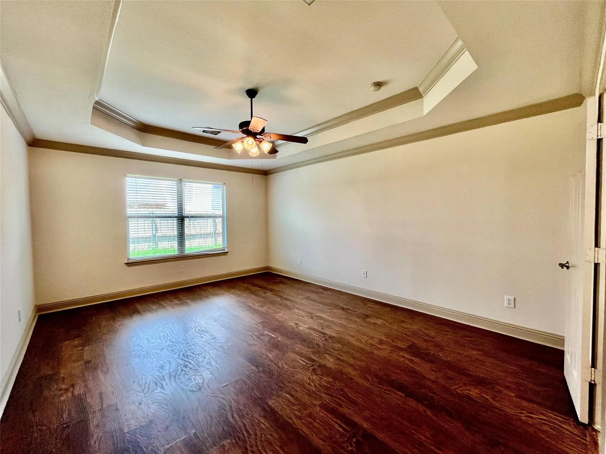 Bedroom with wood flooring, ceiling fan, windows, and closet