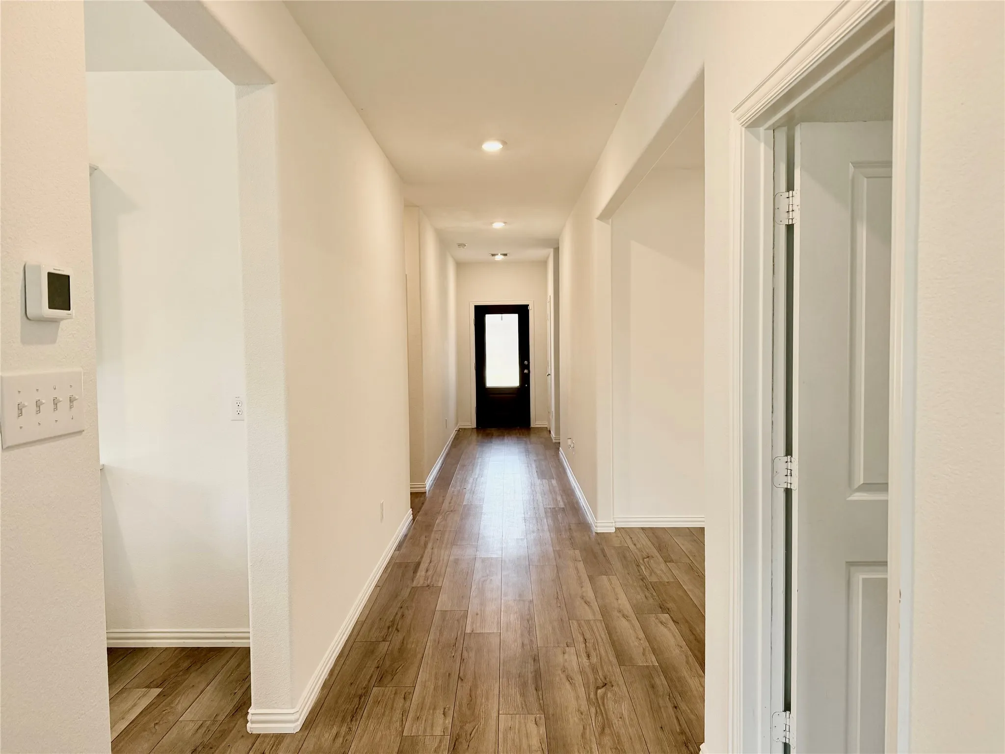 Wood-finish flooring throughout the hallway