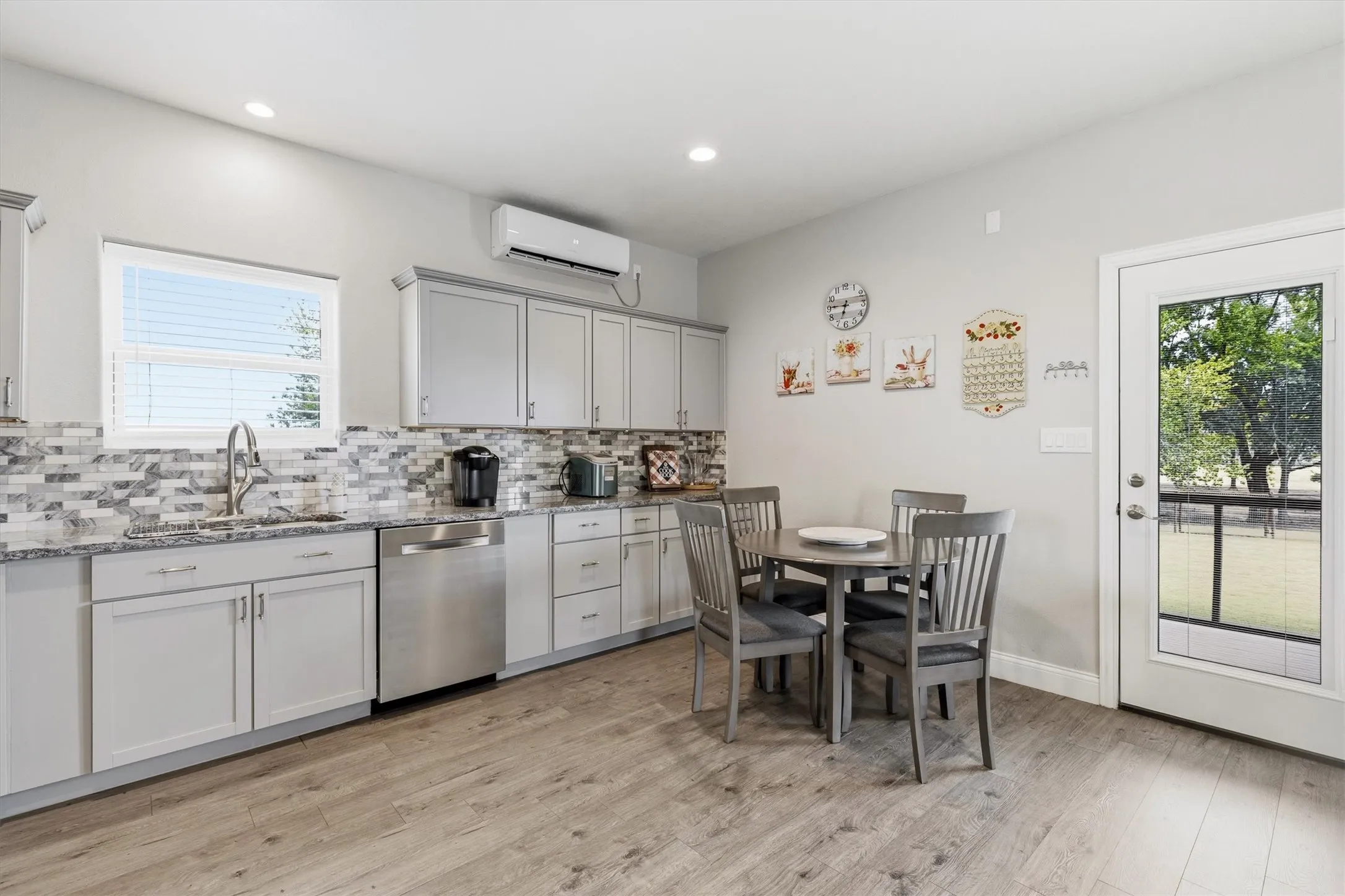 This guest house (ADU) offers a stylish kitchen with a perfect eating area.  Plenty of cabinet and counter space, recessed lights and vinyl flooring.