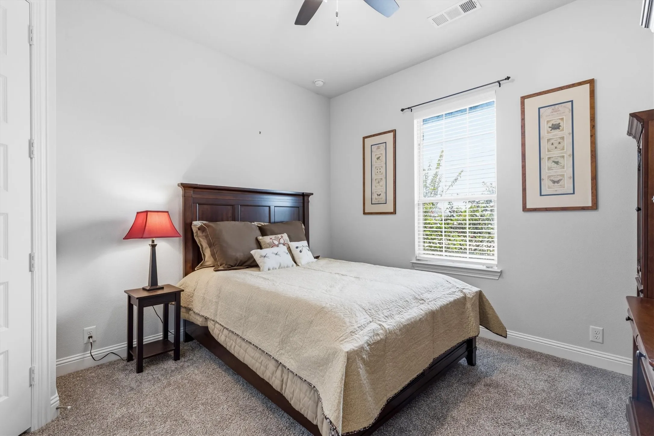 This front bedroom features a large window, corner closet, 8 ft. hardwood doors. A full bathroom just outside the door adds convenience for guests, family or a home office.