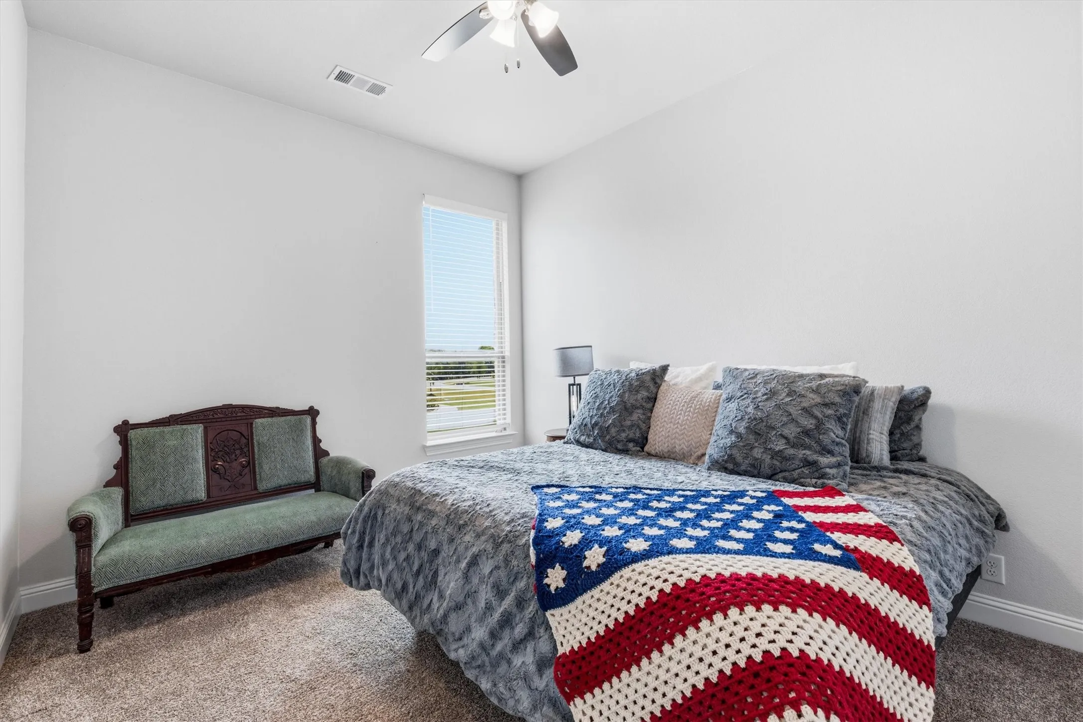 Bright and inviting secondary bedroom with a walk-in closet.
