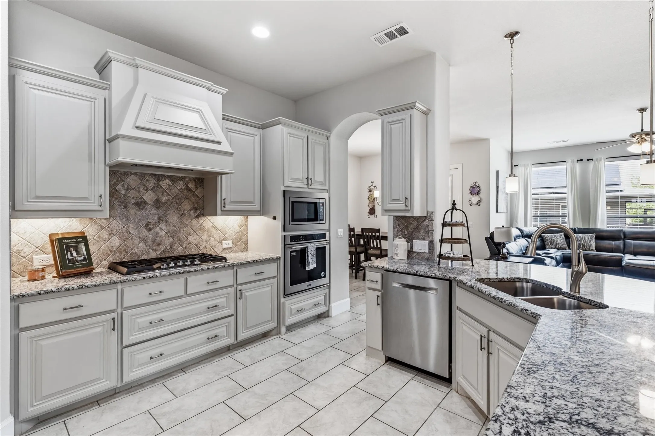 Custom vent hood, gas cooktop, built-ins and large island.