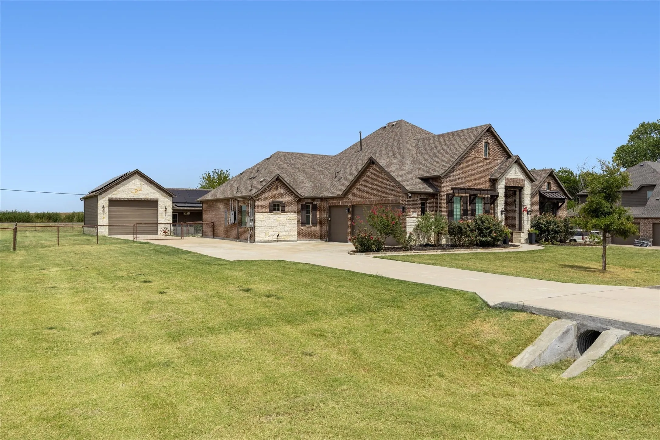 Stonehollow brick home with a separate guest house offering 2,801 sq. ft. in the main home plus an additional 902 sq. ft. More space for extended families, live-in arrangements, guests, or a private home office.