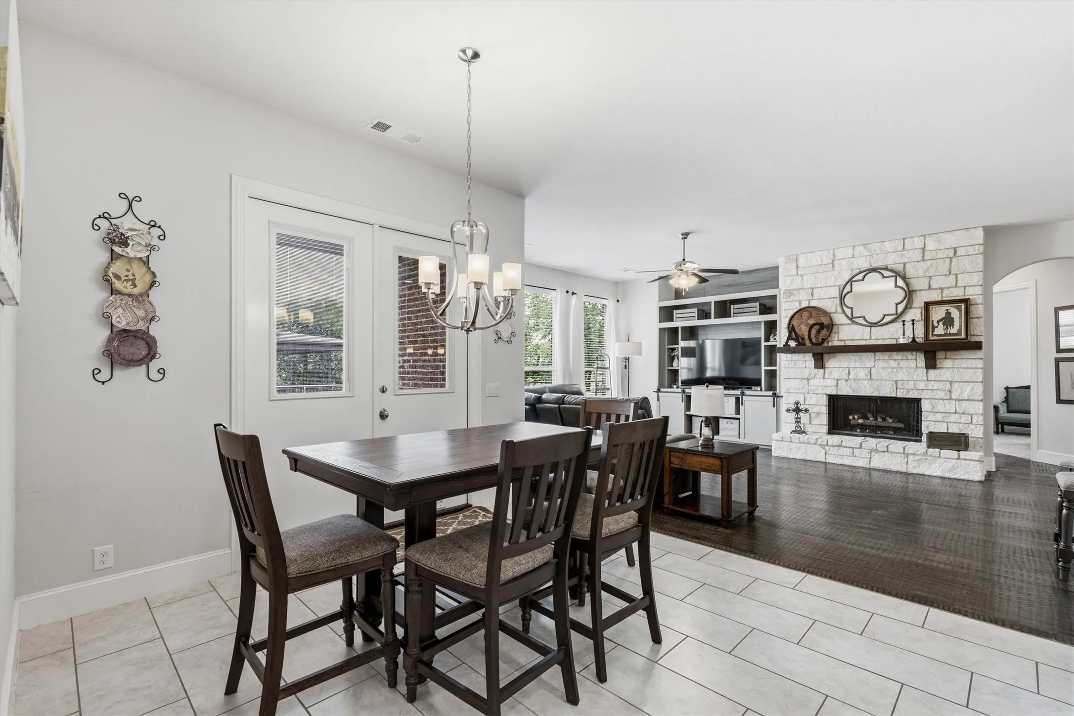Casual tiled, eating space that opens into the family room, with double doors leading out to the patio.