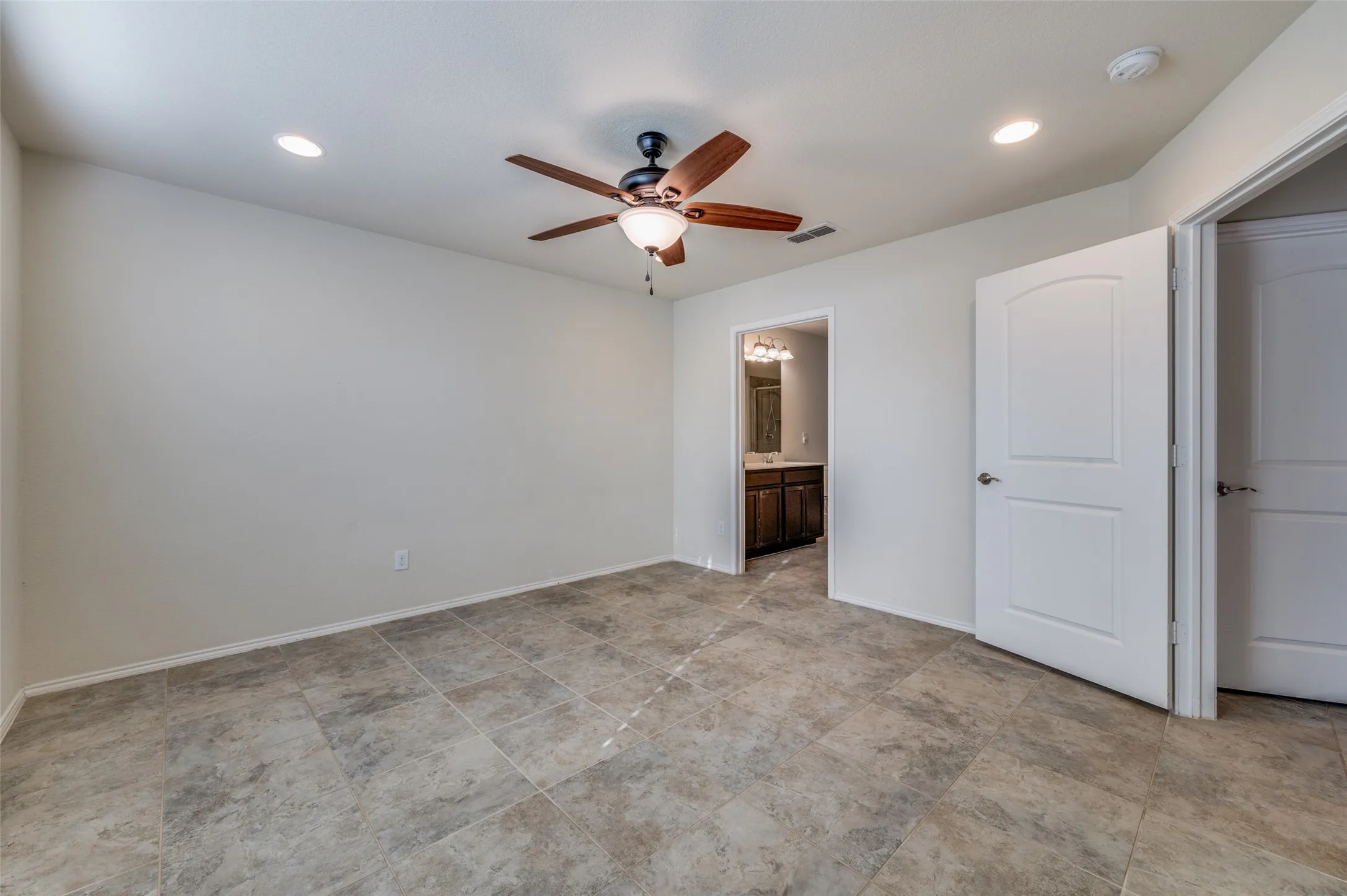 Recessed lighting, ceiling fan with light fixture, tile flooring, and white interior doors
