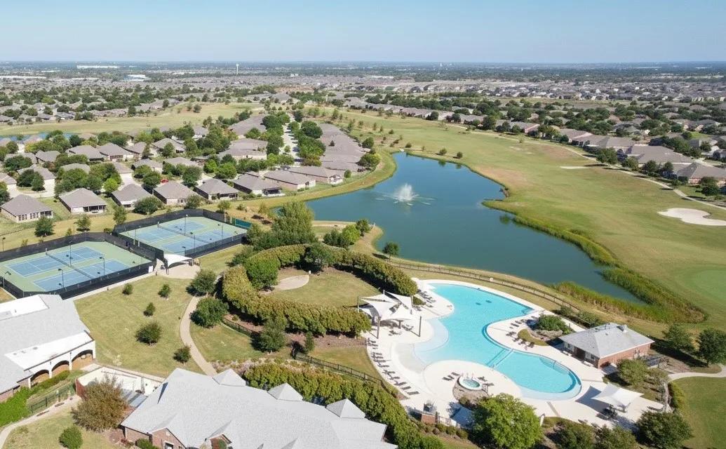 Community amenities featuring a resort-style pool with integrated spa, tennis courts, and a tranquil pond with fountain, all surrounded by green spaces