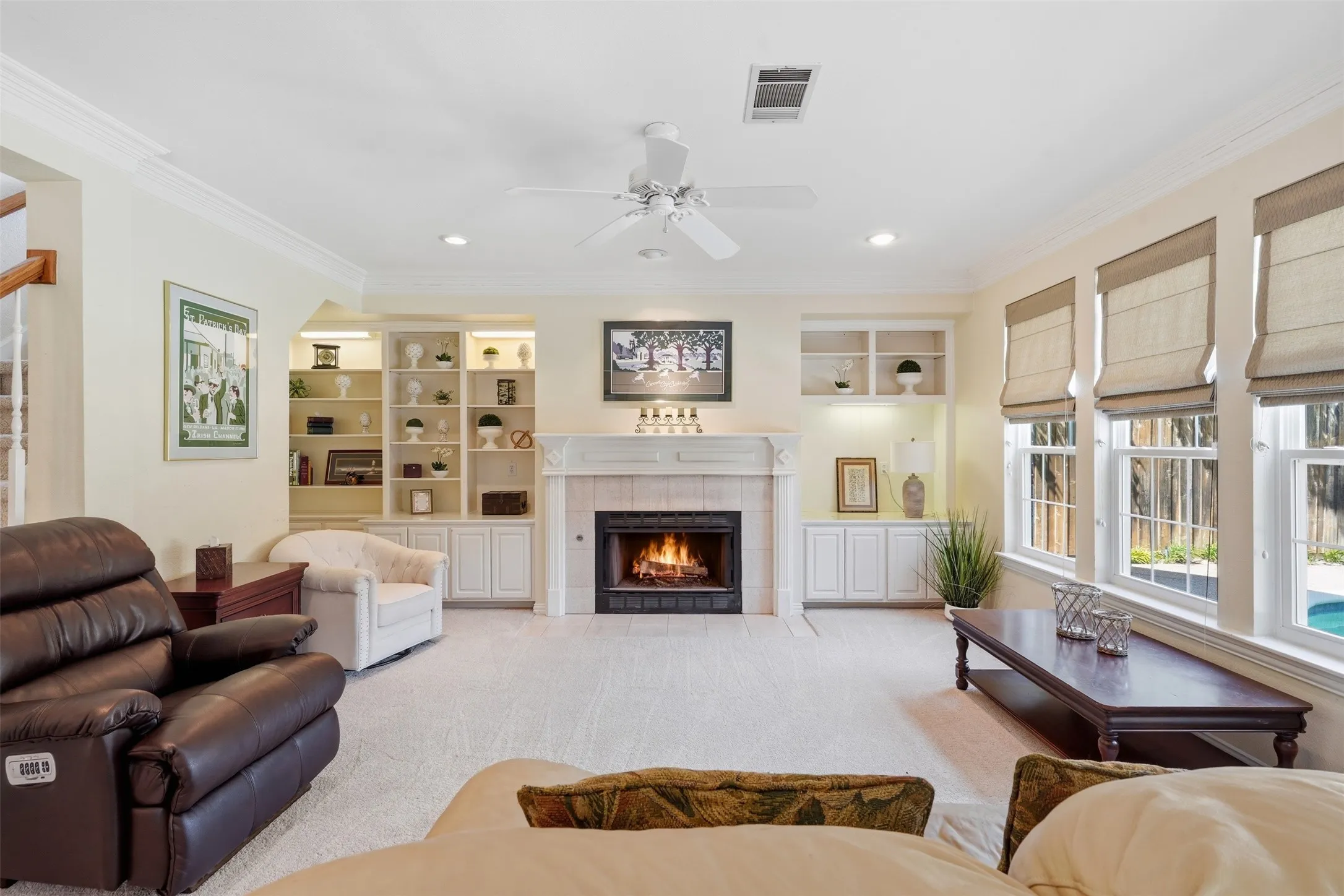Living room with a centered fireplace featuring a tile surround and mantel