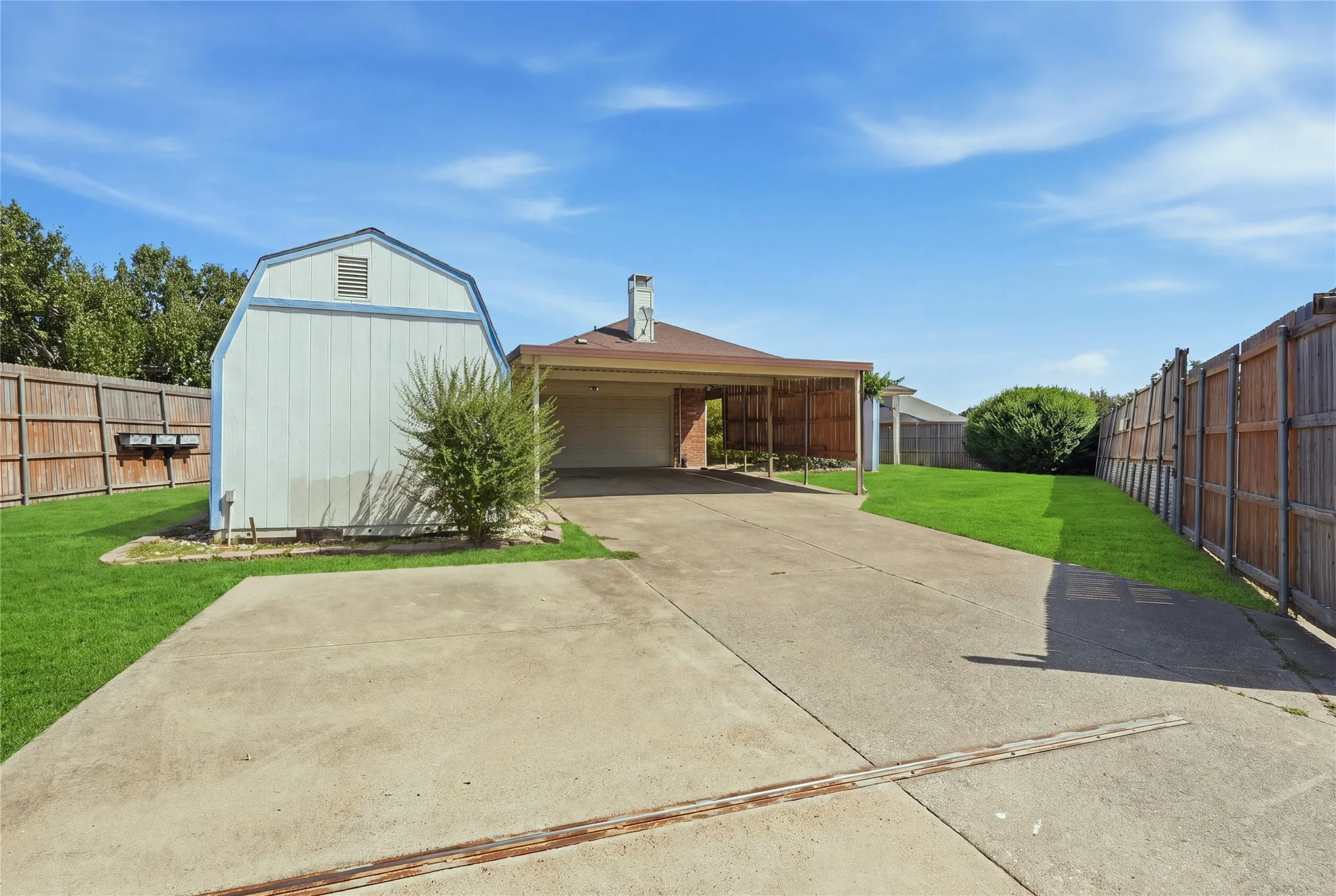 Inside gated entry; driveway, carport, & garage entryway