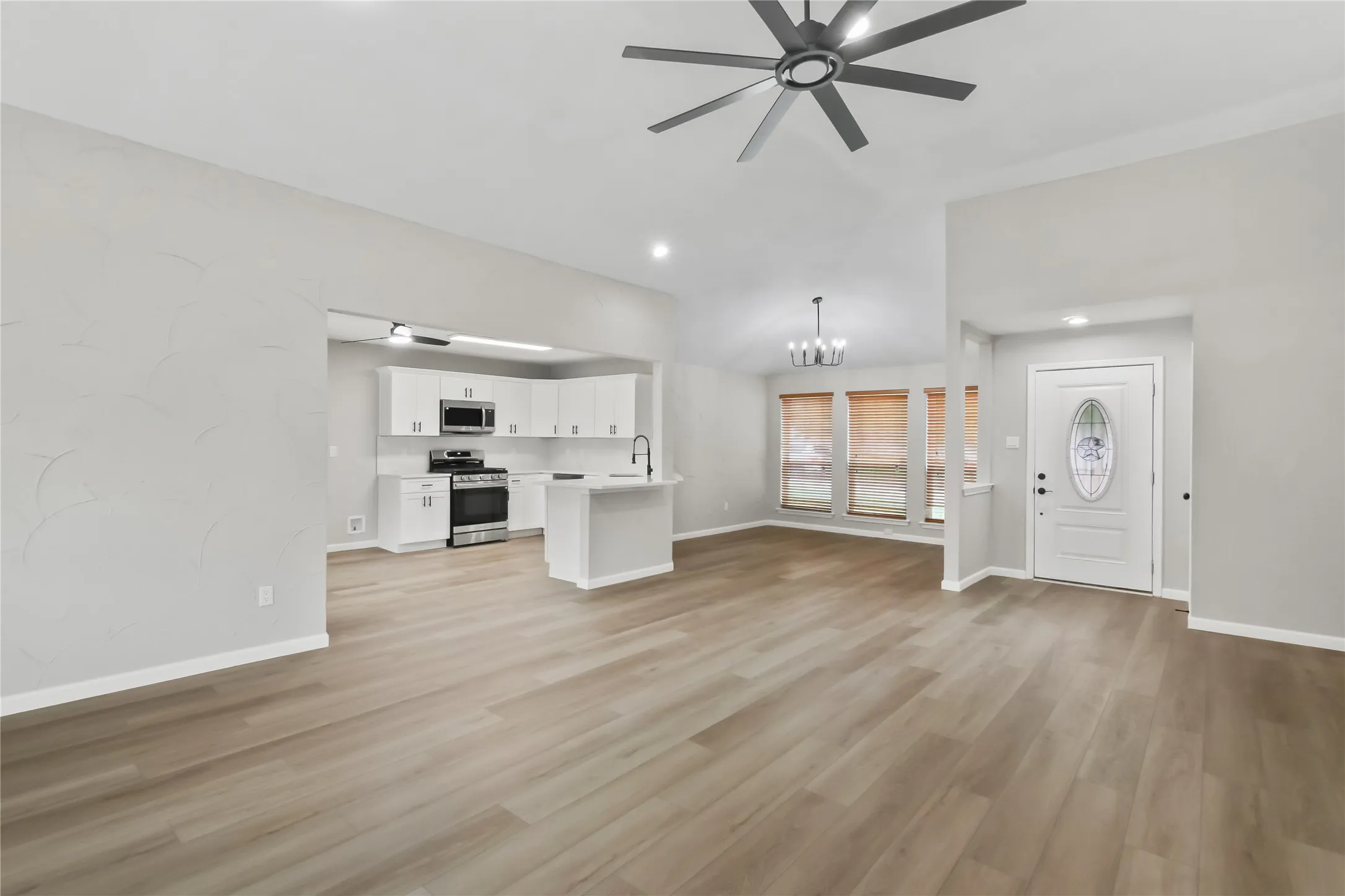 Vaulted ceilings, wood-finish flooring, and recessed lighting