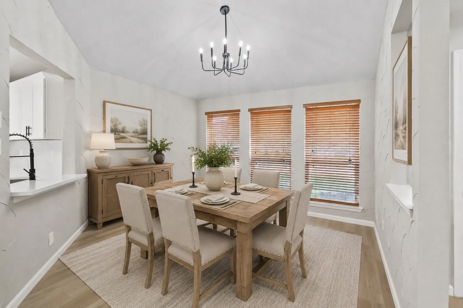 Recessed lighting, wood-finish flooring, and a contemporary chandelier