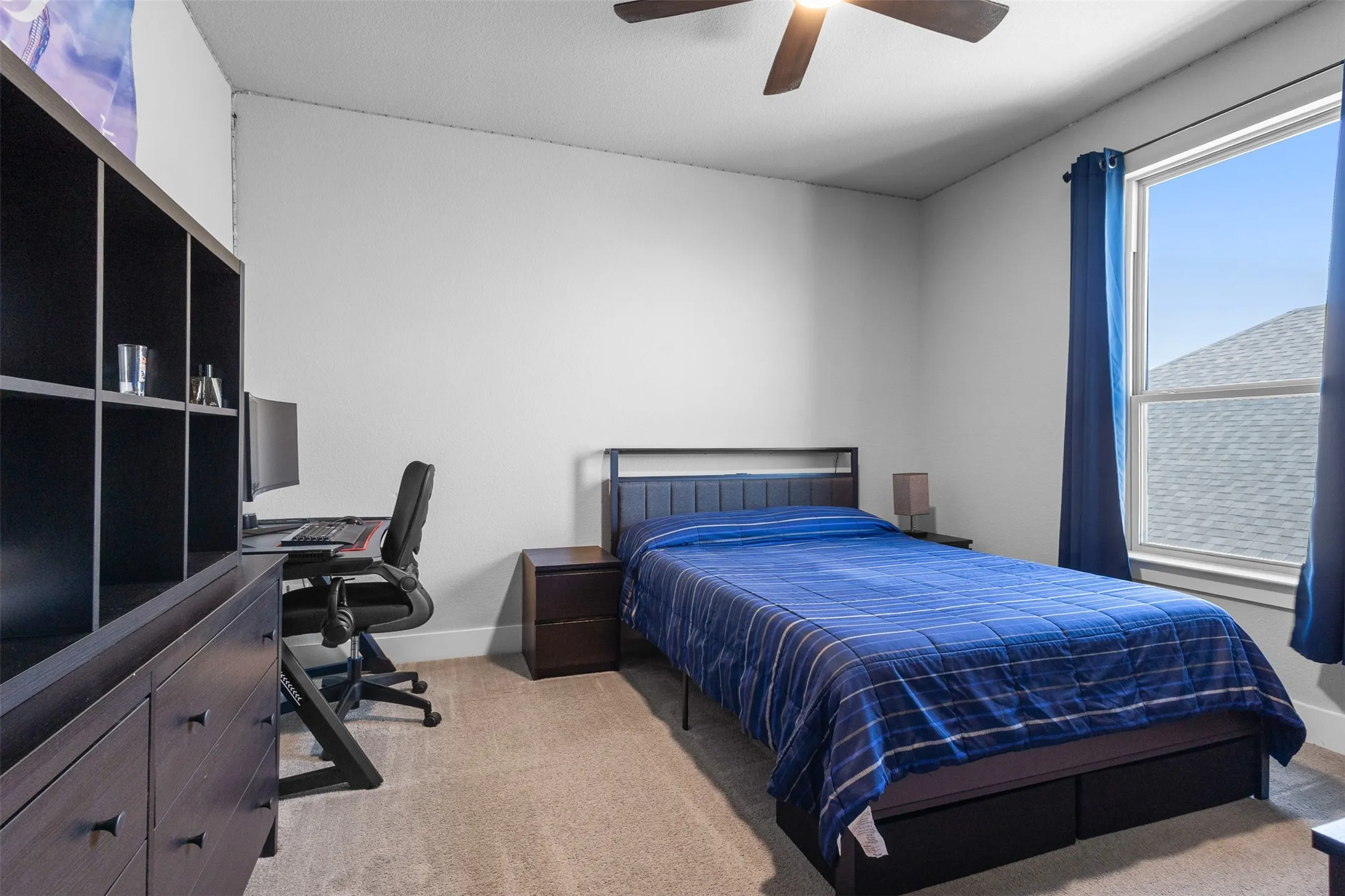 Recessed lighting, ceiling fan, carpeting, built-in shelving, and a large window