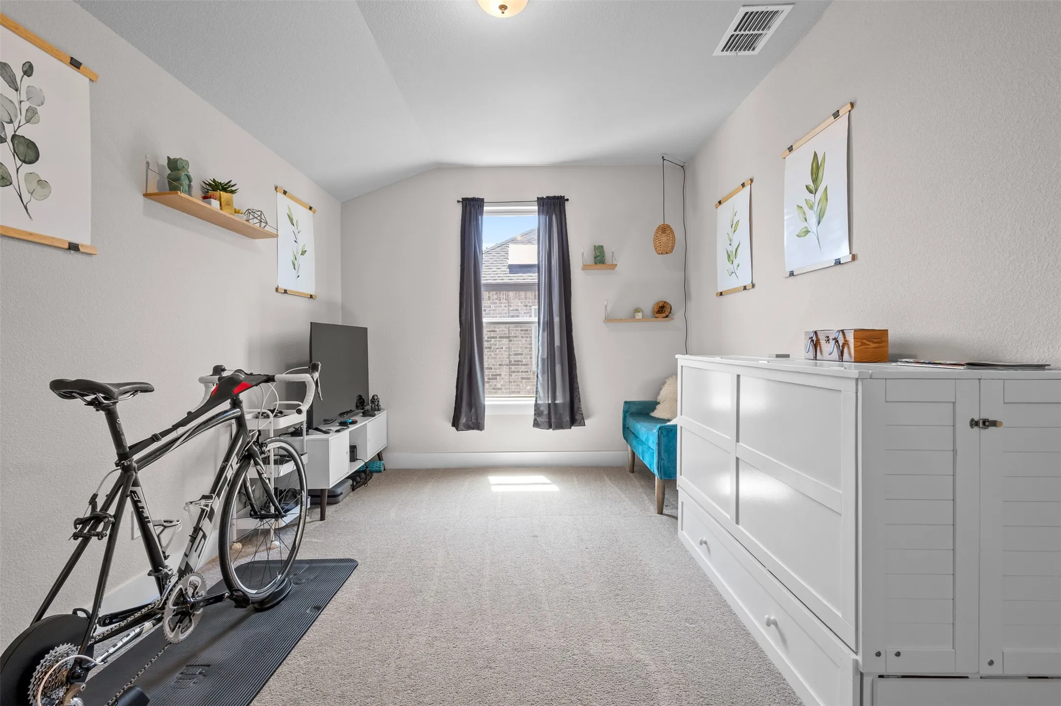 Neutral-toned walls complement the light-colored carpet flooring
