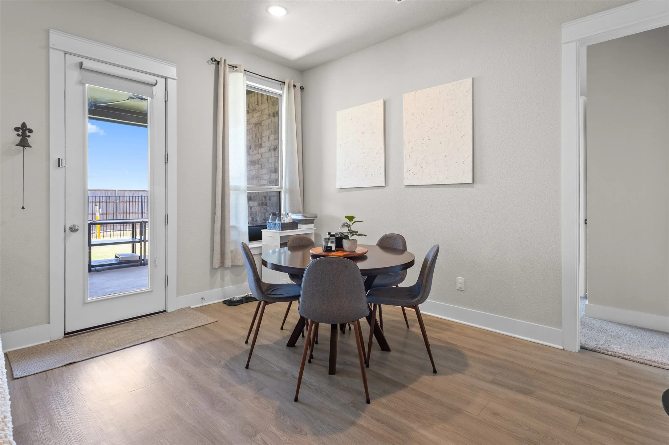 Wood-finish flooring, recessed lighting, and a full-light door providing exterior access
