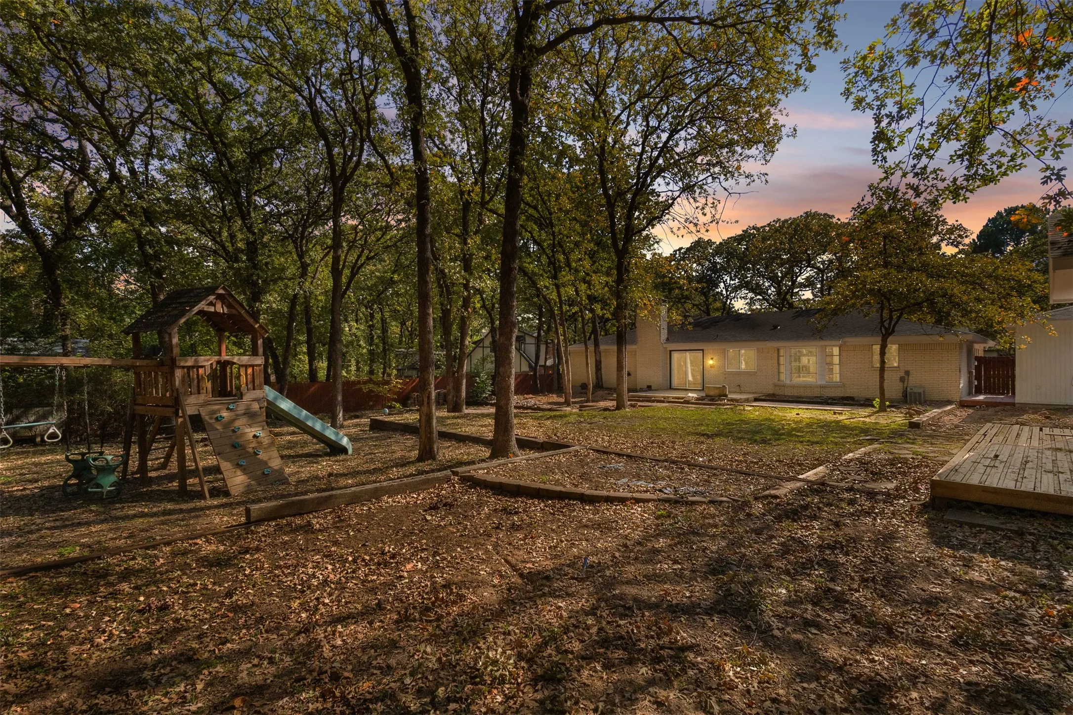 View of yard with a playground and a patio