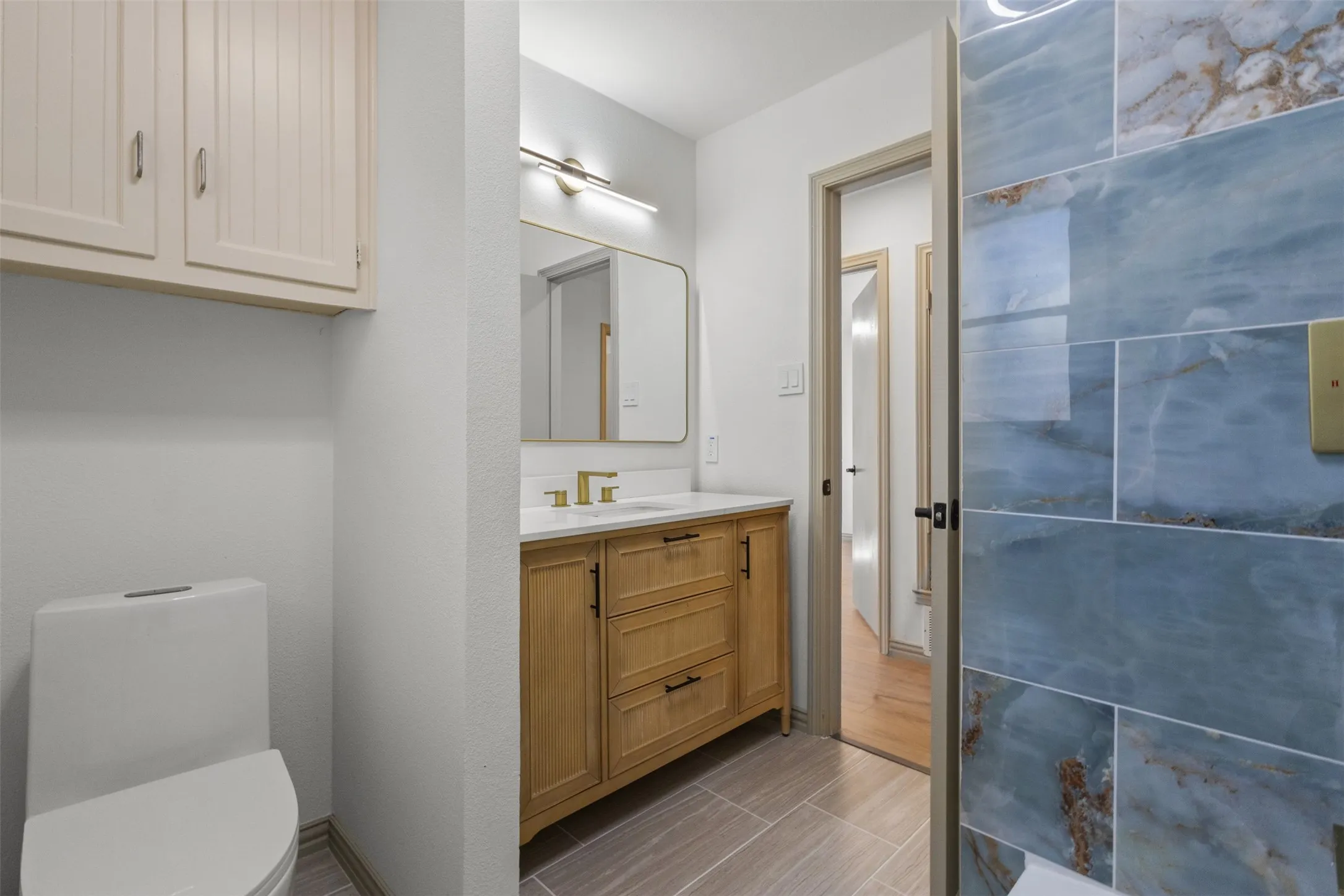 Half bathroom featuring vanity and toilet
