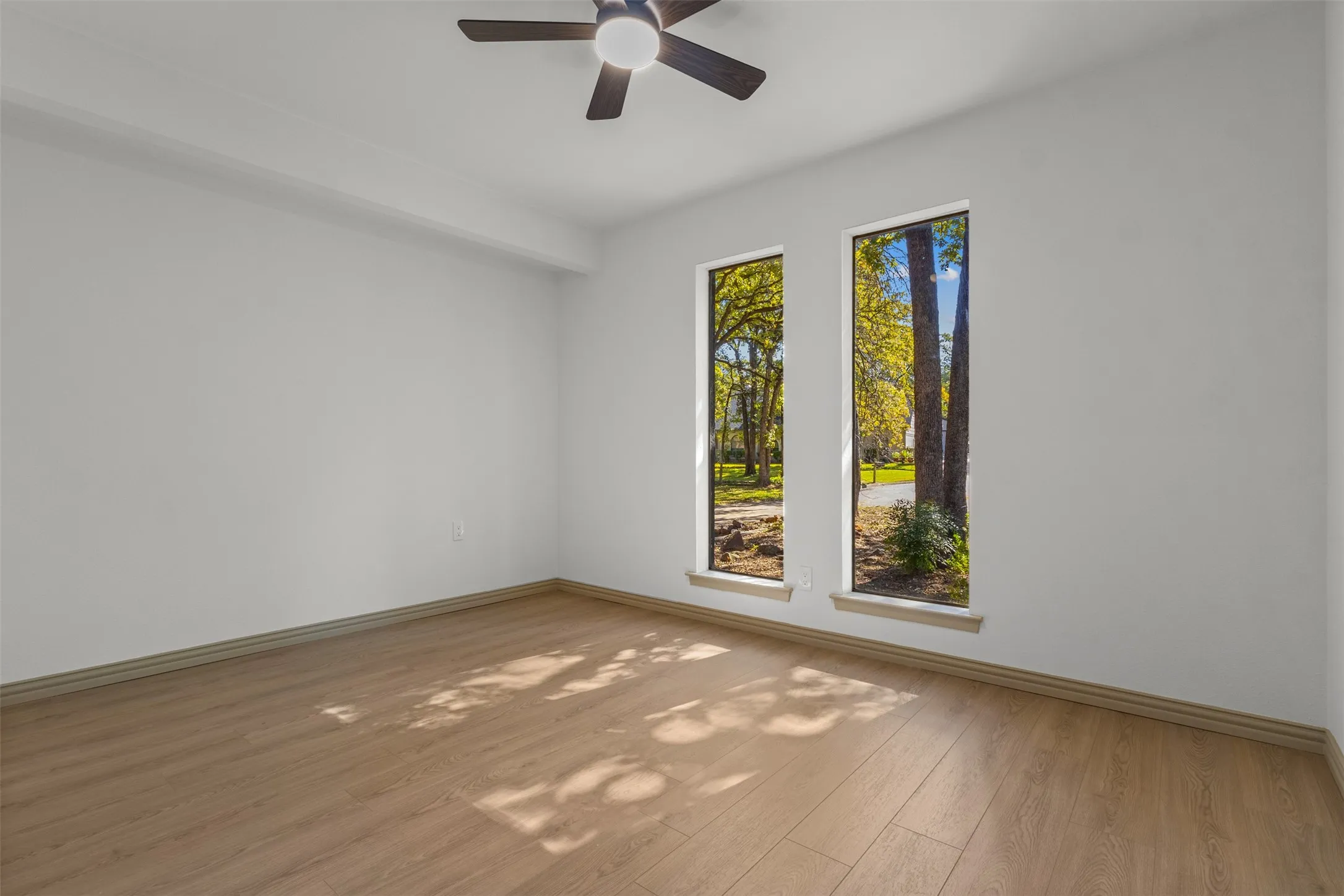 Spare room featuring light wood-style floors and ceiling fan