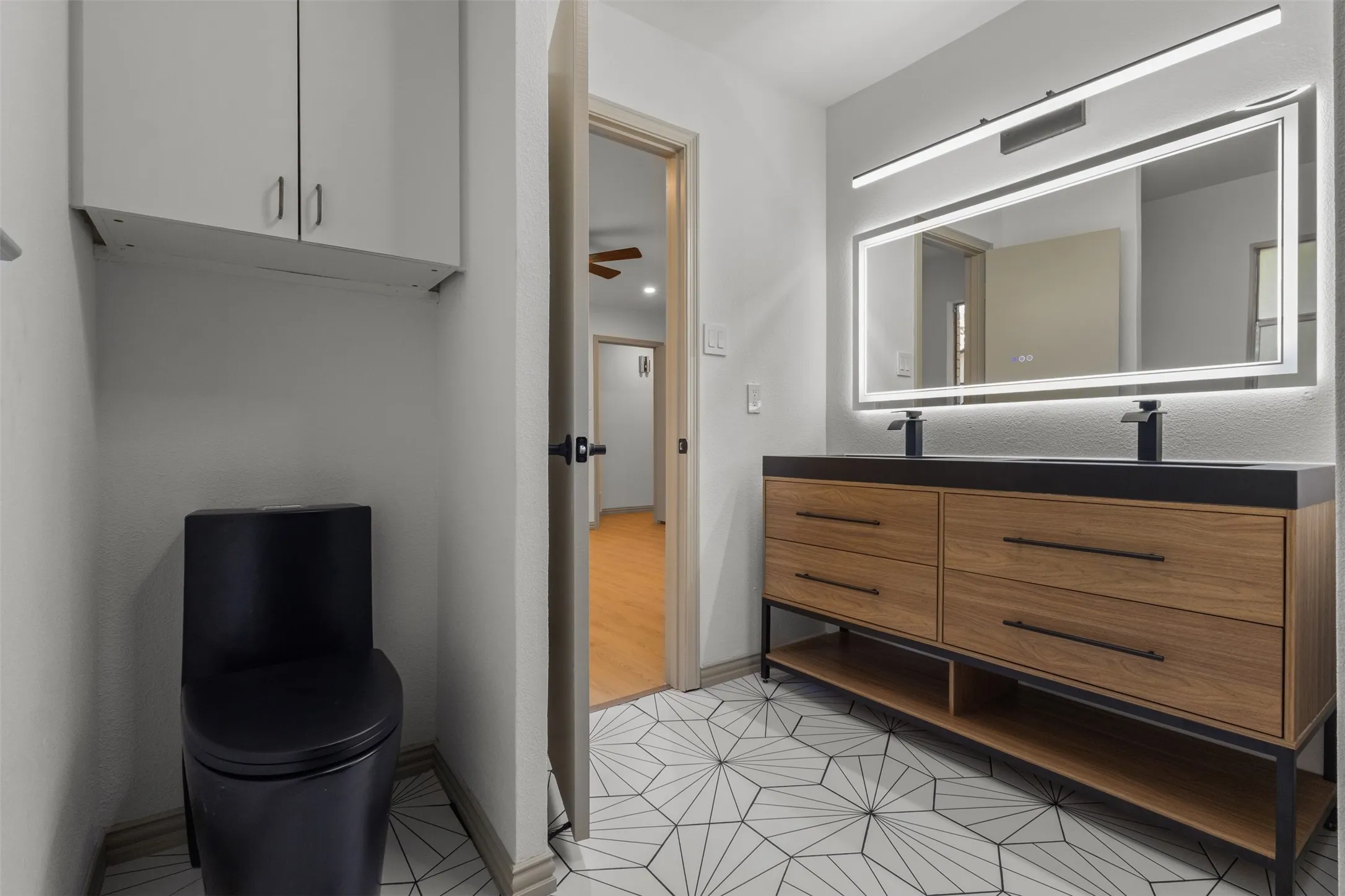 Bathroom featuring double vanity and light tile patterned flooring
