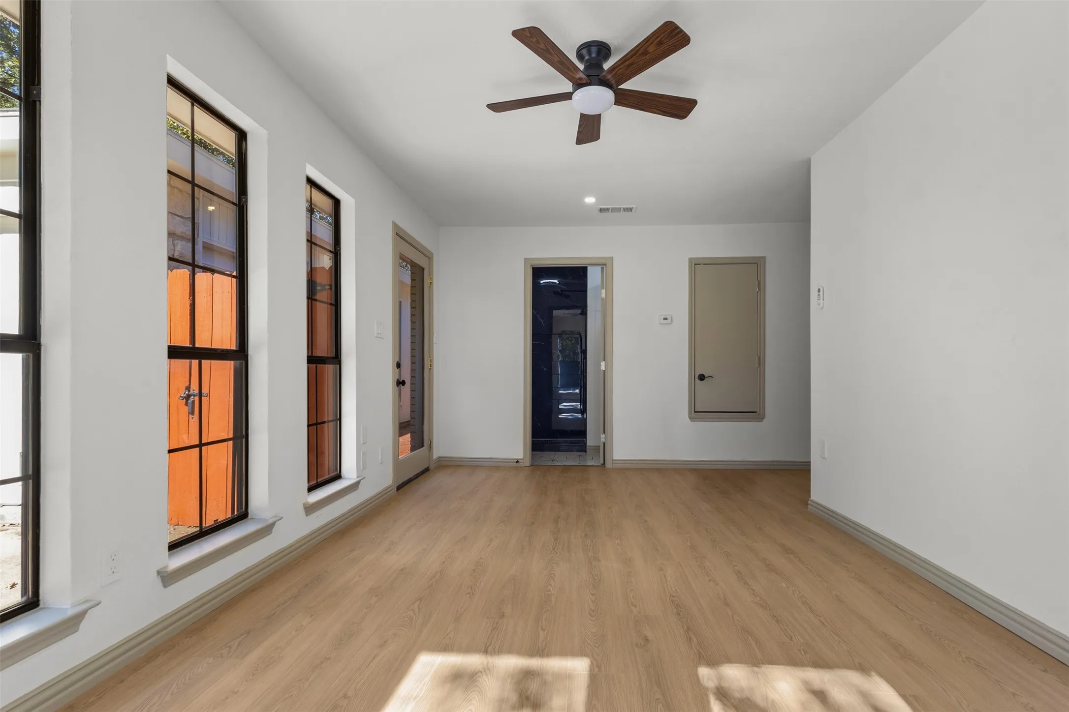 Empty room featuring light wood-type flooring and ceiling fan
