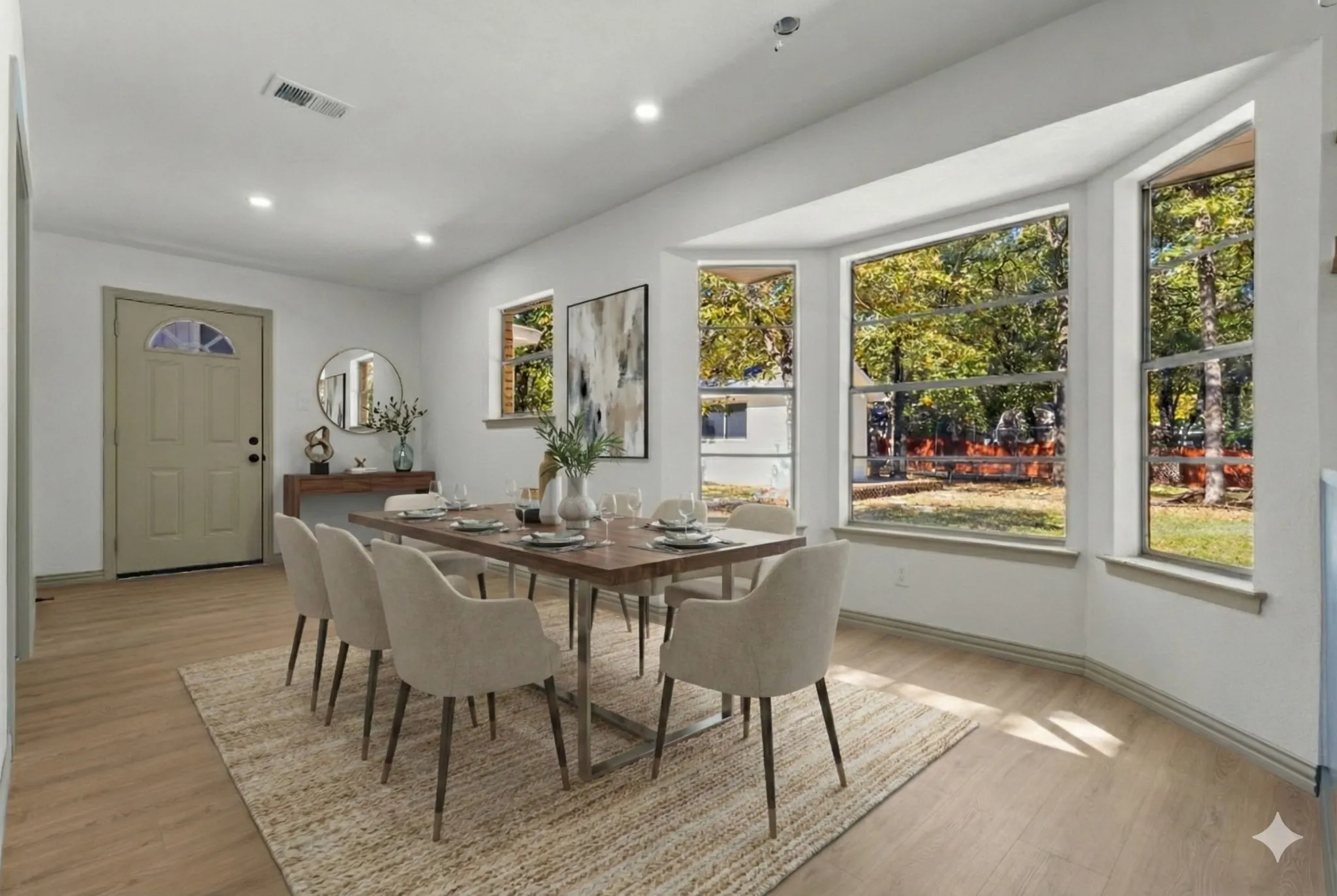 Dining space with light wood-style floors and recessed lighting