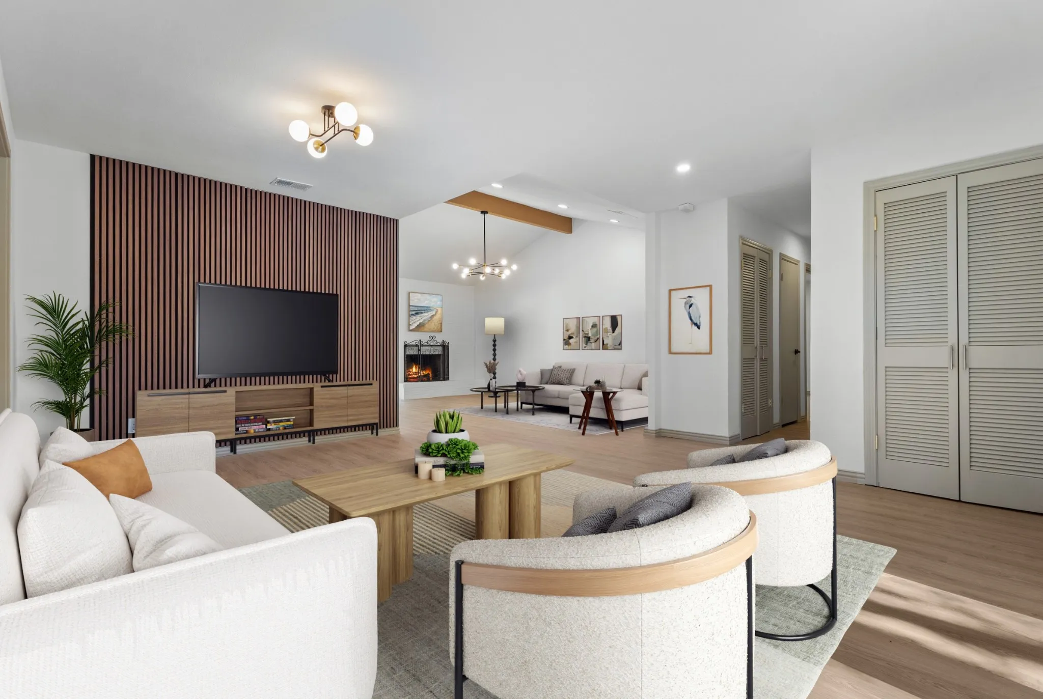 Living room with light wood-style floors, a chandelier, recessed lighting, and a warm lit fireplace