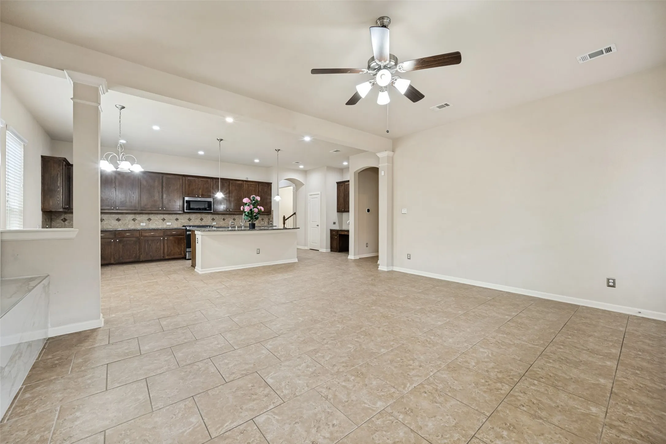 Spacious open-concept living area with large format tile flooring