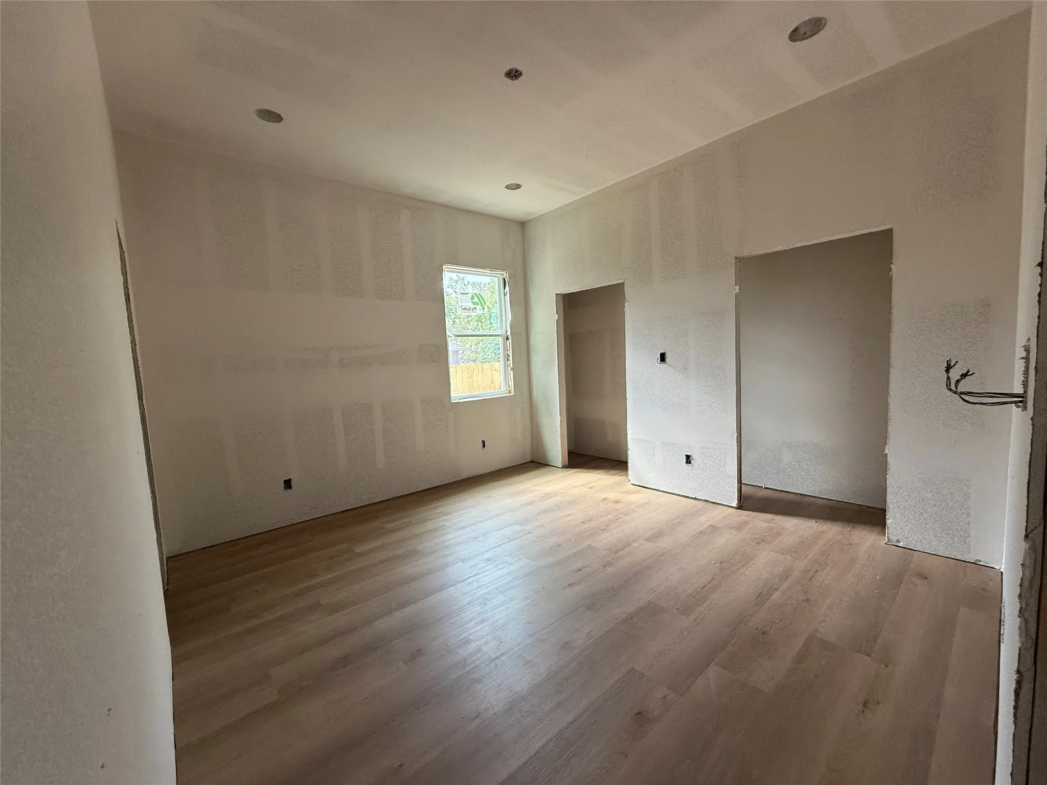 Recessed ceiling lighting, wood-finish flooring, and multiple window openings