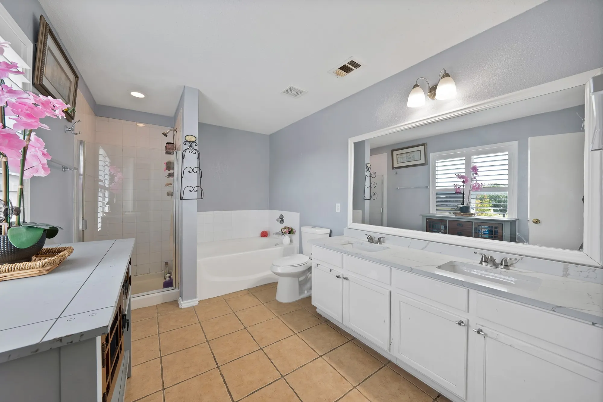 Dual vanity with white cabinetry and integrated sinks