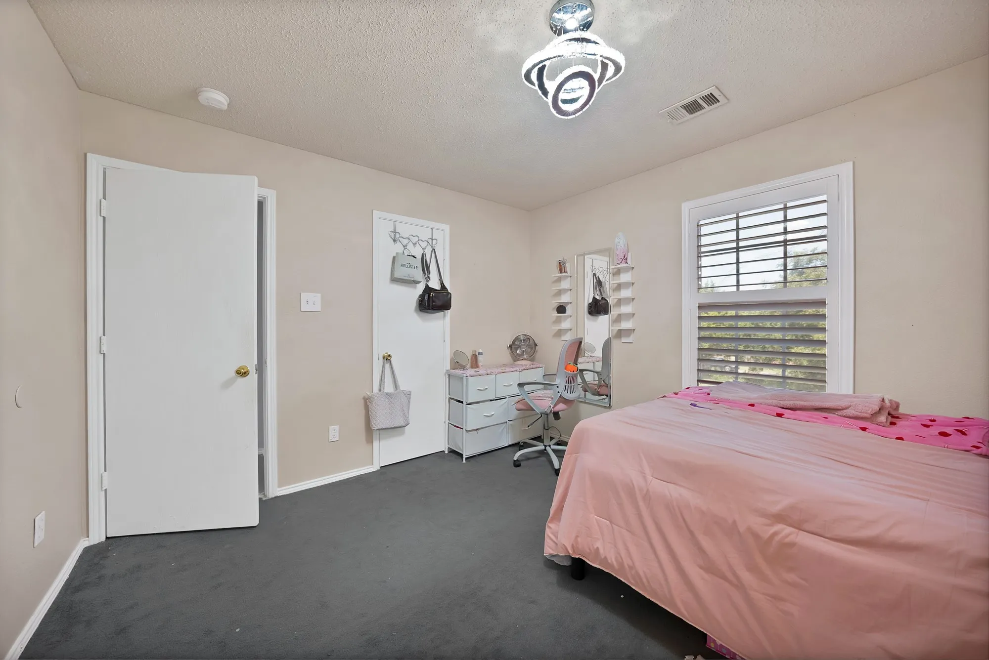 Window with horizontal blinds, overhead ceiling light fixture, and neutral wall paint