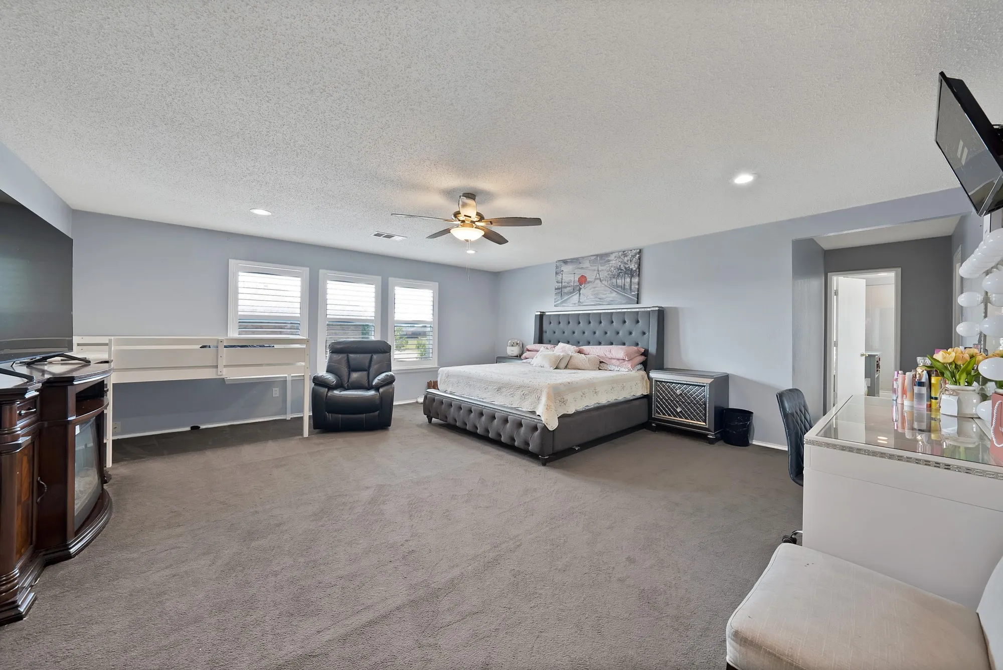 Expansive room featuring recessed lighting, a ceiling fan, and multiple windows