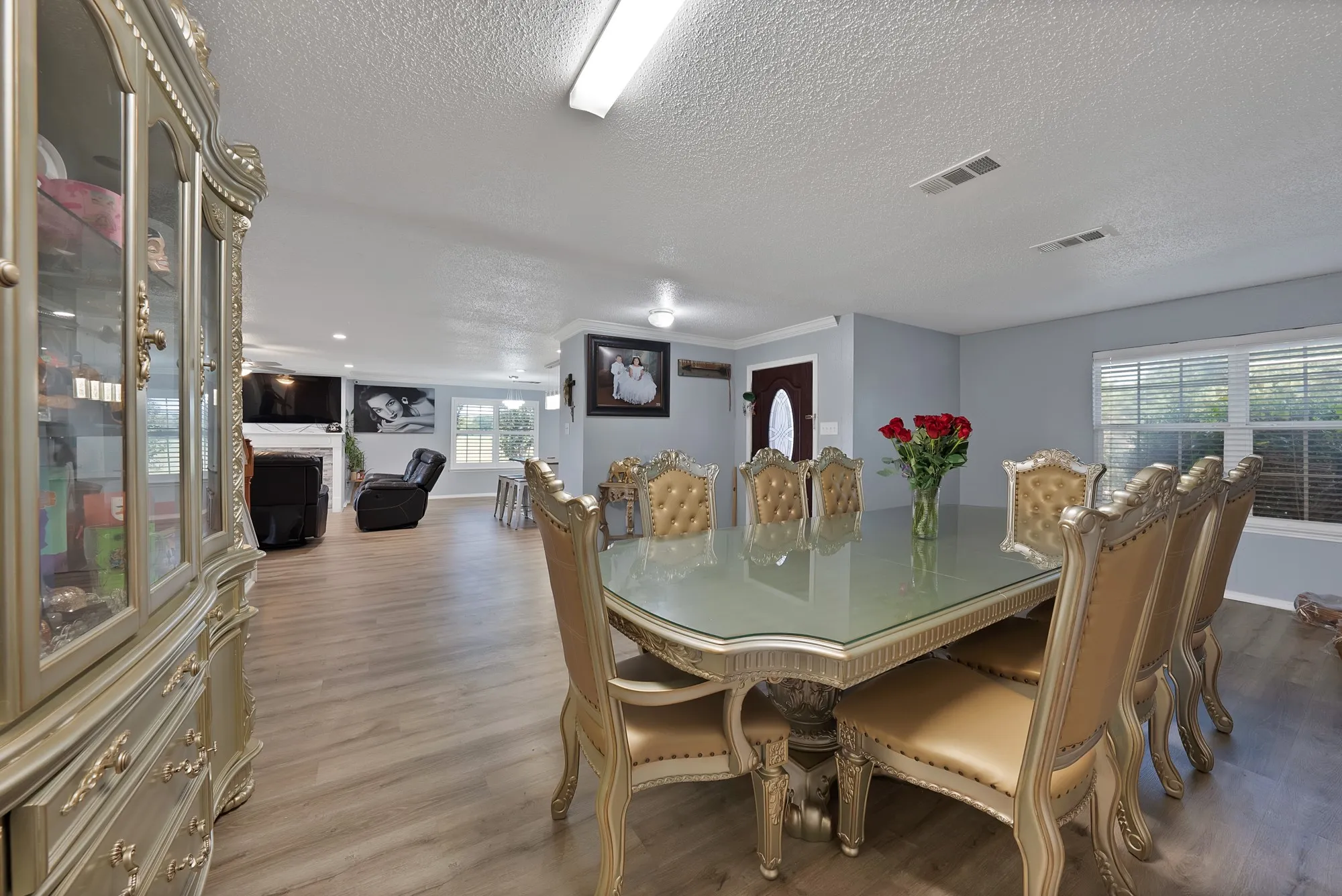 Wood-finish flooring throughout, light gray wall paint, and multiple windows with blinds