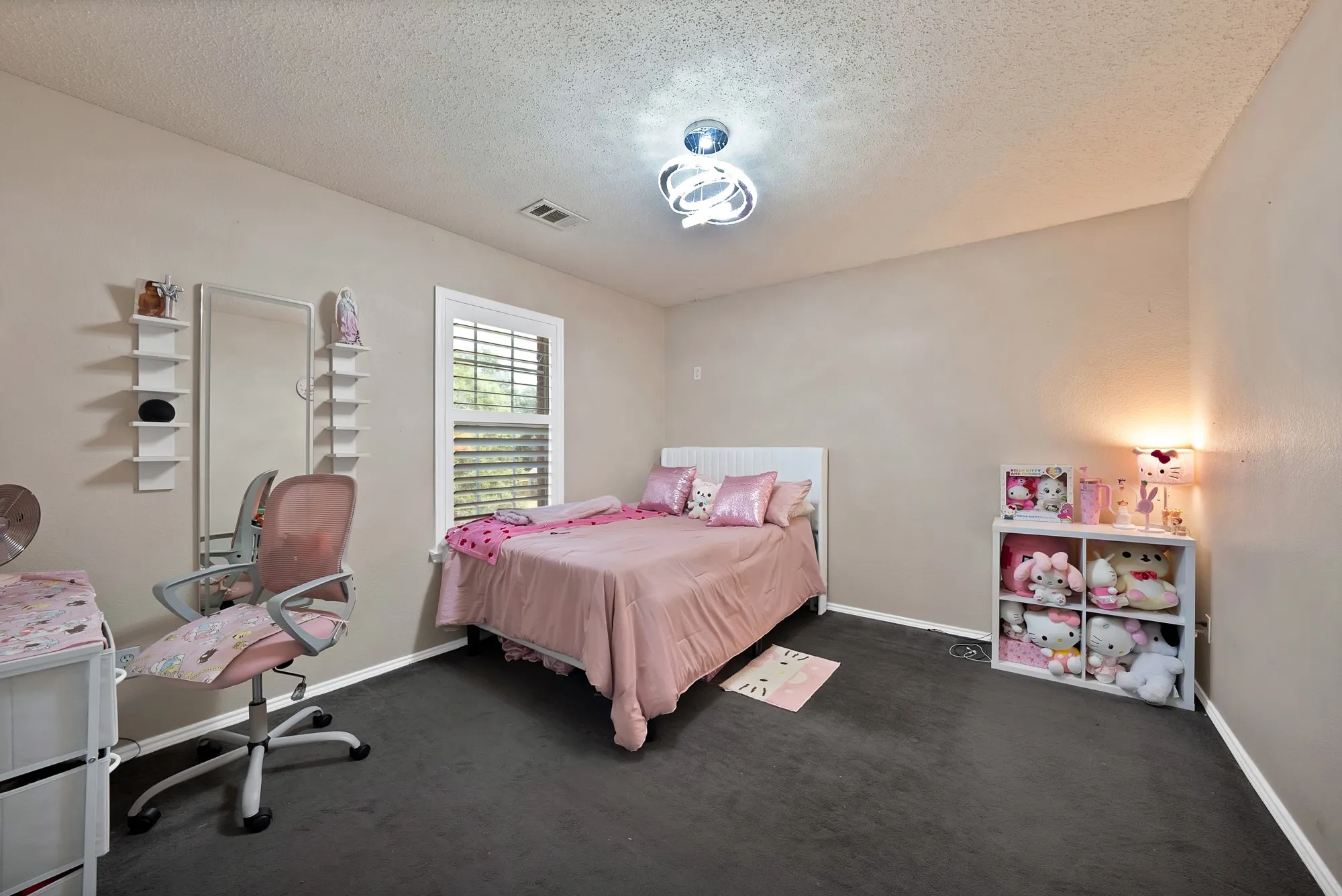 Recessed lighting with a modern ceiling fixture, dark carpeting, and a white window with louvered shutters
