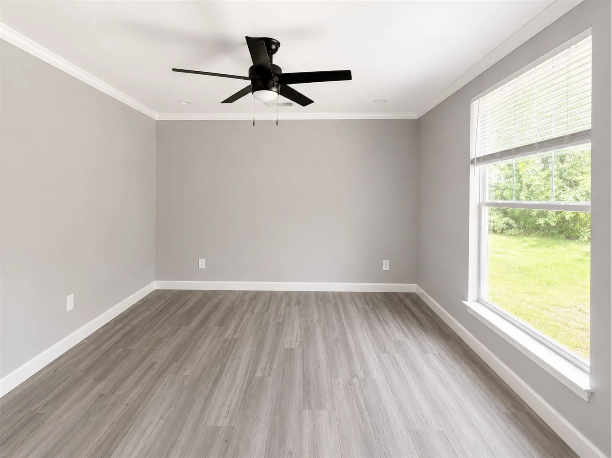 Recessed lighting, wood-finish flooring, ceiling fan with light fixture, window with blinds, and white trim throughout