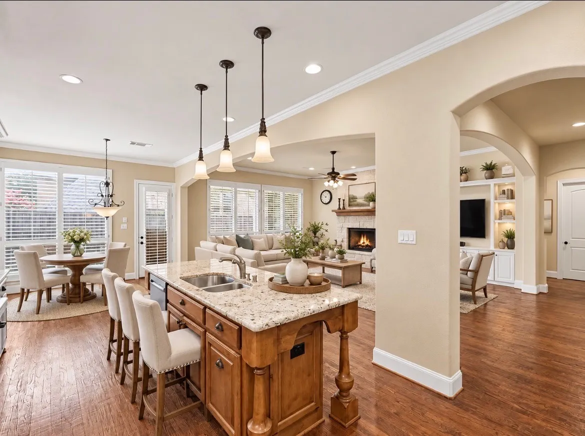 Kitchen island with granite countertop, double basin sink, and pendant lighting