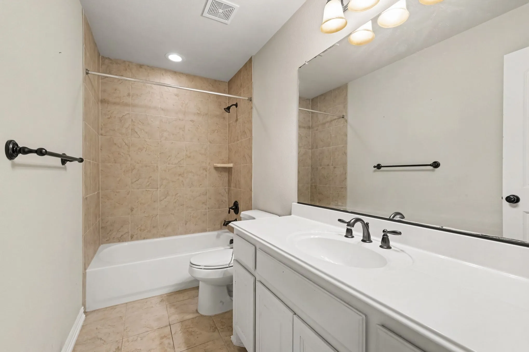 Bathroom featuring a single vanity with a white countertop, under-mount sink, and dark-toned fixtures. Located in secondary masterbdrm