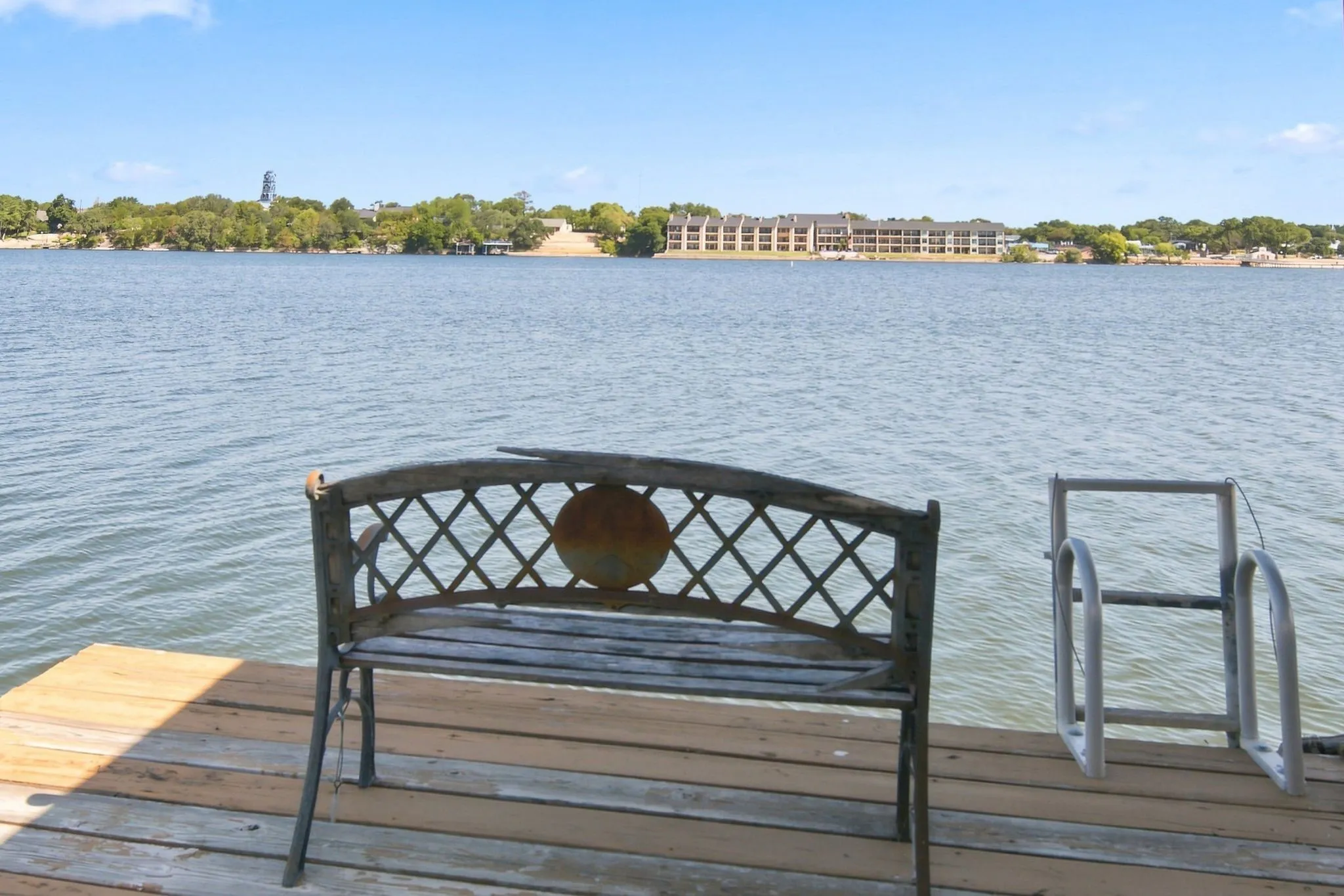 Dock with wood planking and metal ladder access to the water