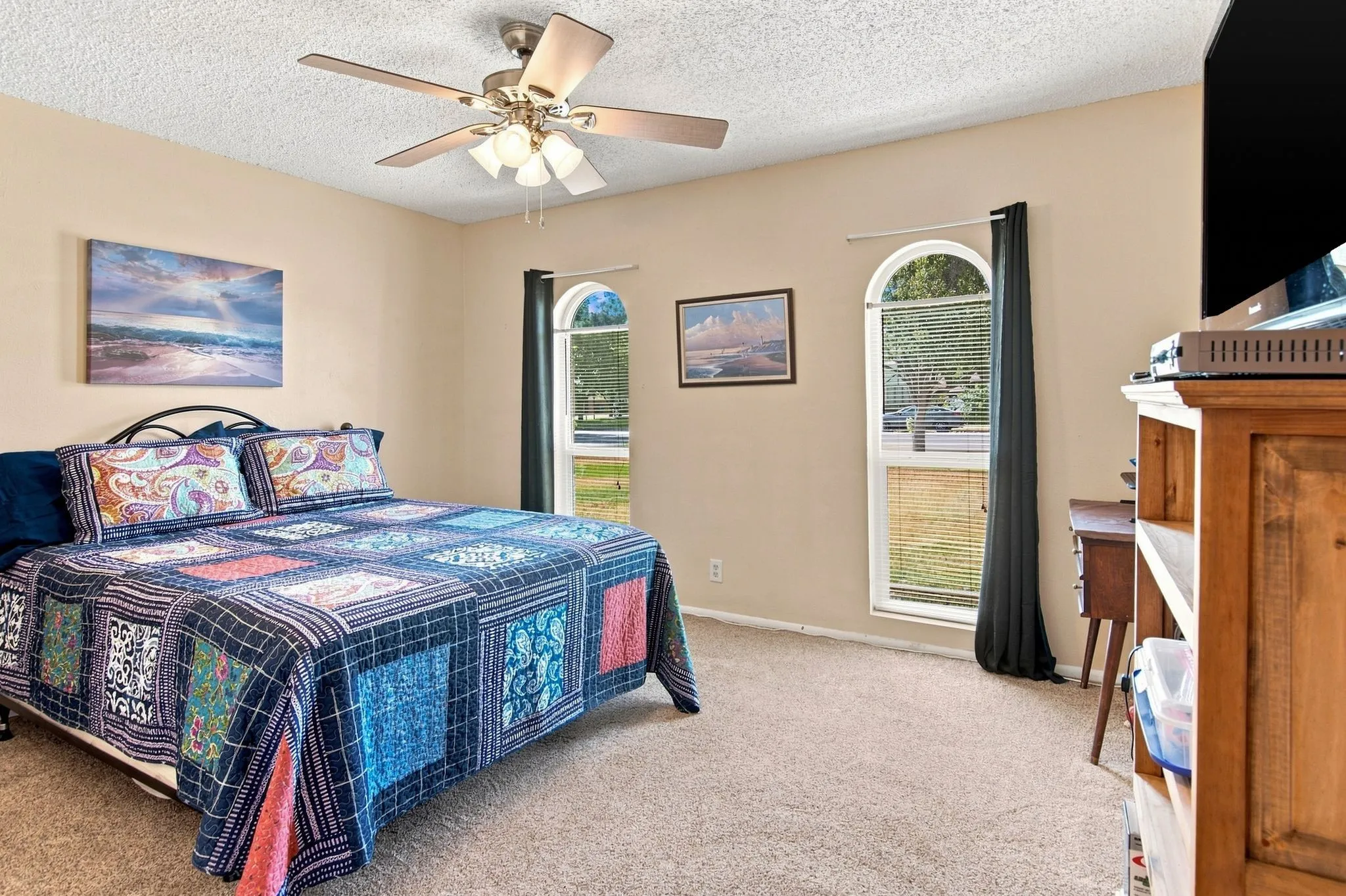 Neutral-toned walls complement the carpeted flooring