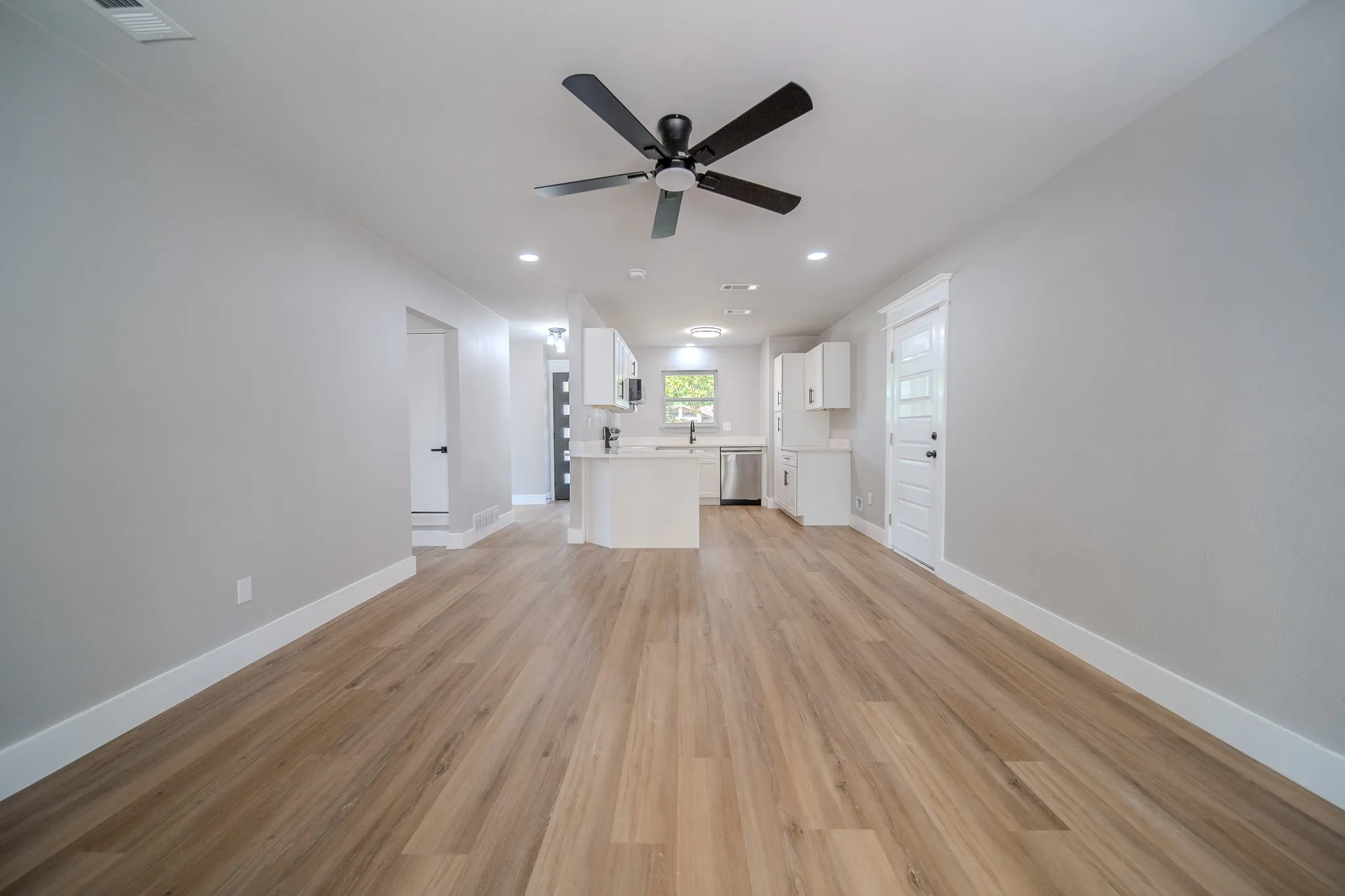Wood-finish flooring, recessed lighting, and a ceiling fan