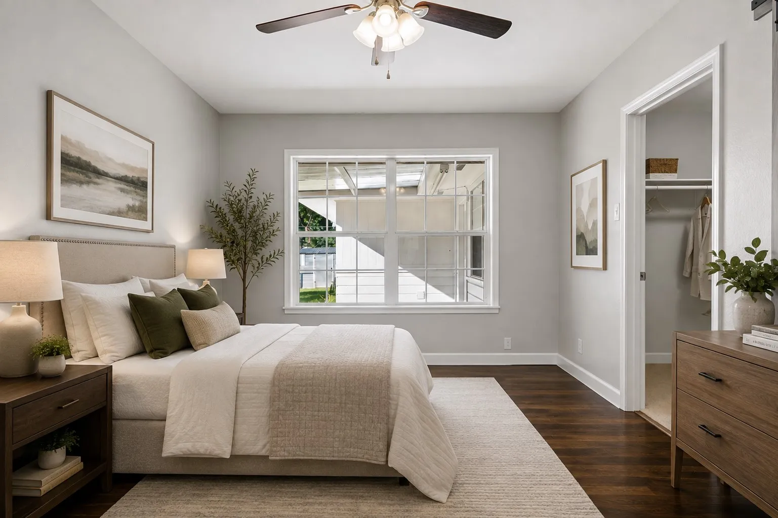 Hardwood-style flooring, white trim, a double-hung window, and a ceiling fan with integrated lighting