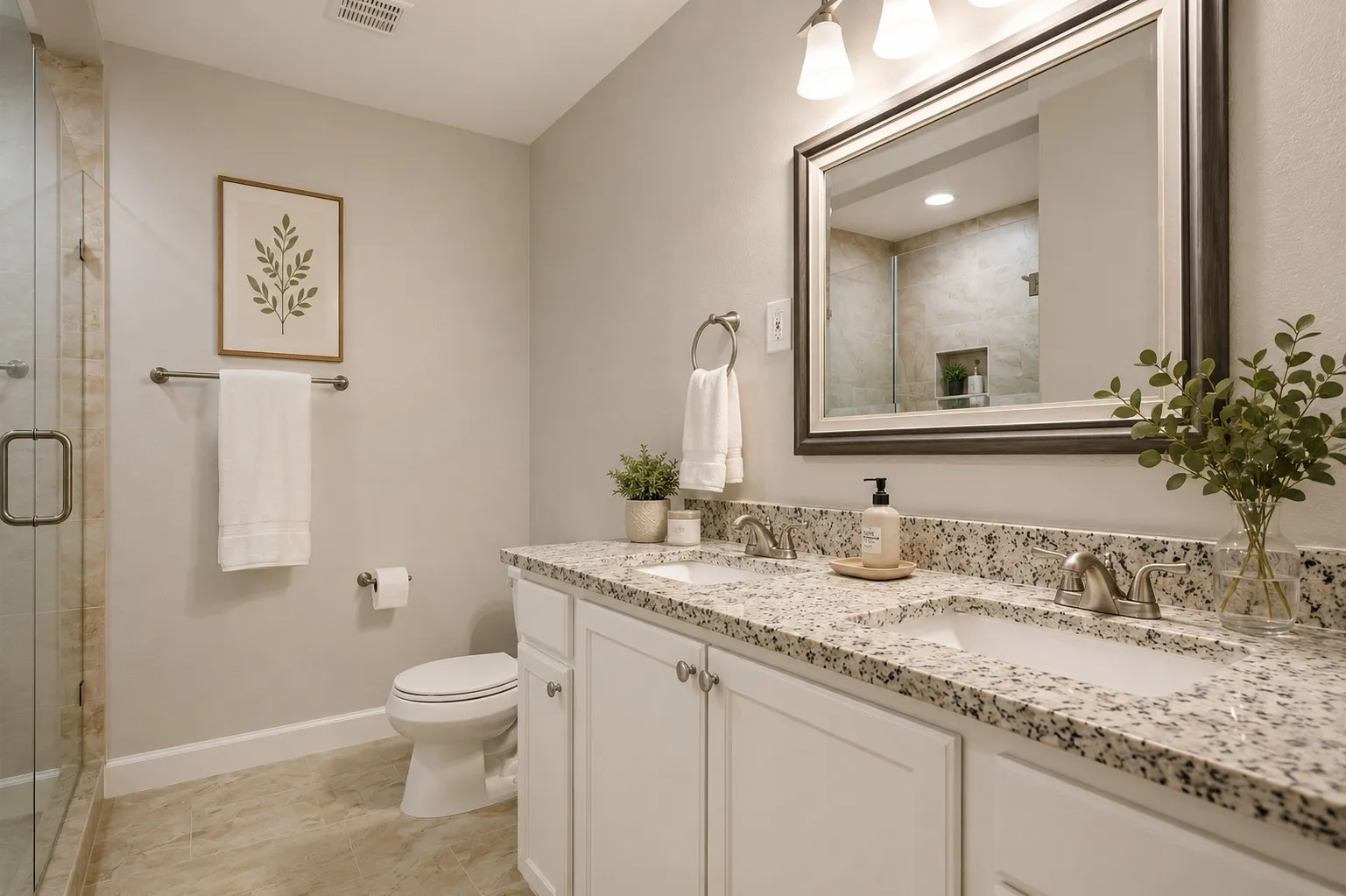Dual vanity with granite countertops, undermount sinks, and brushed nickel fixtures