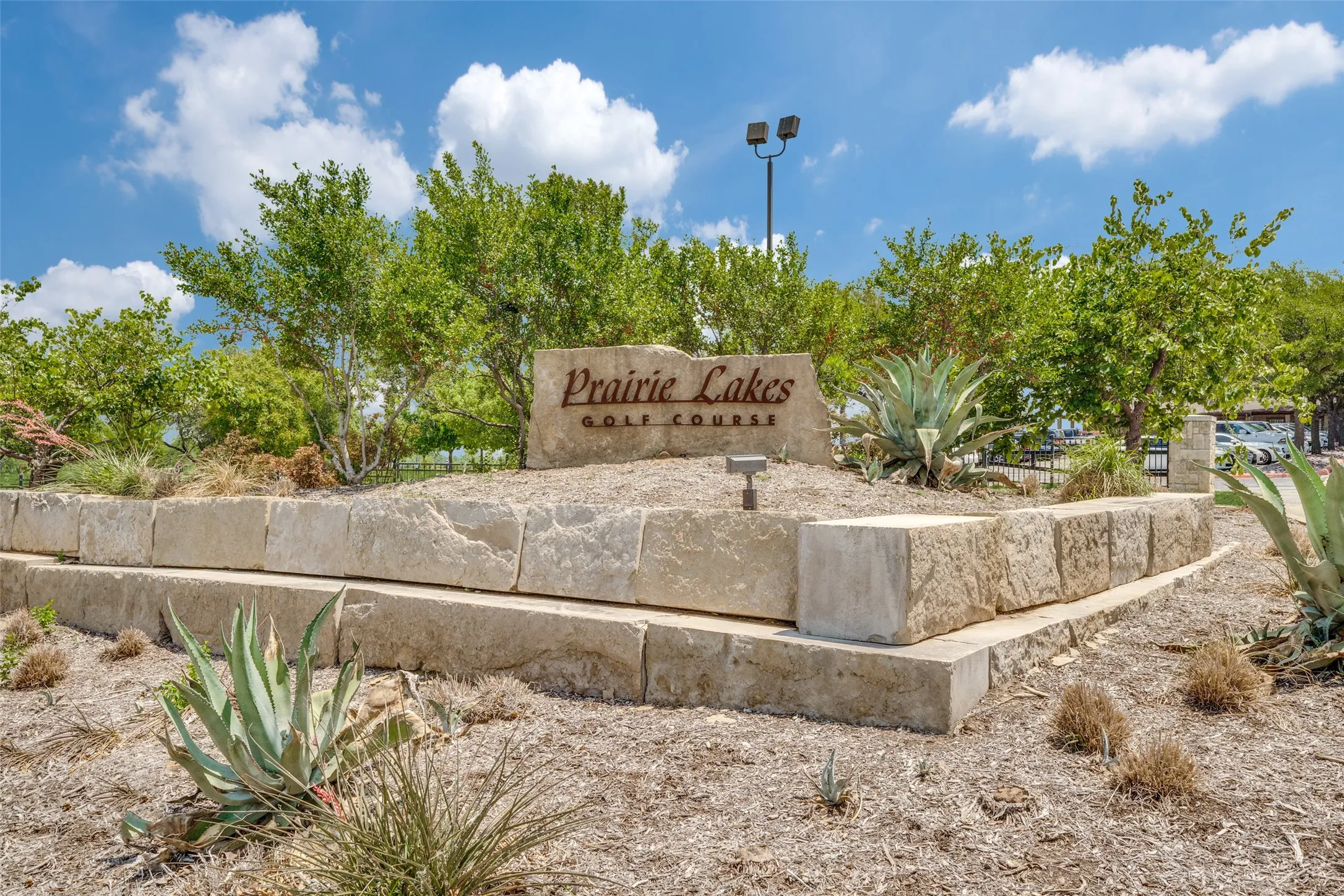 Stone block retaining wall with integrated signage