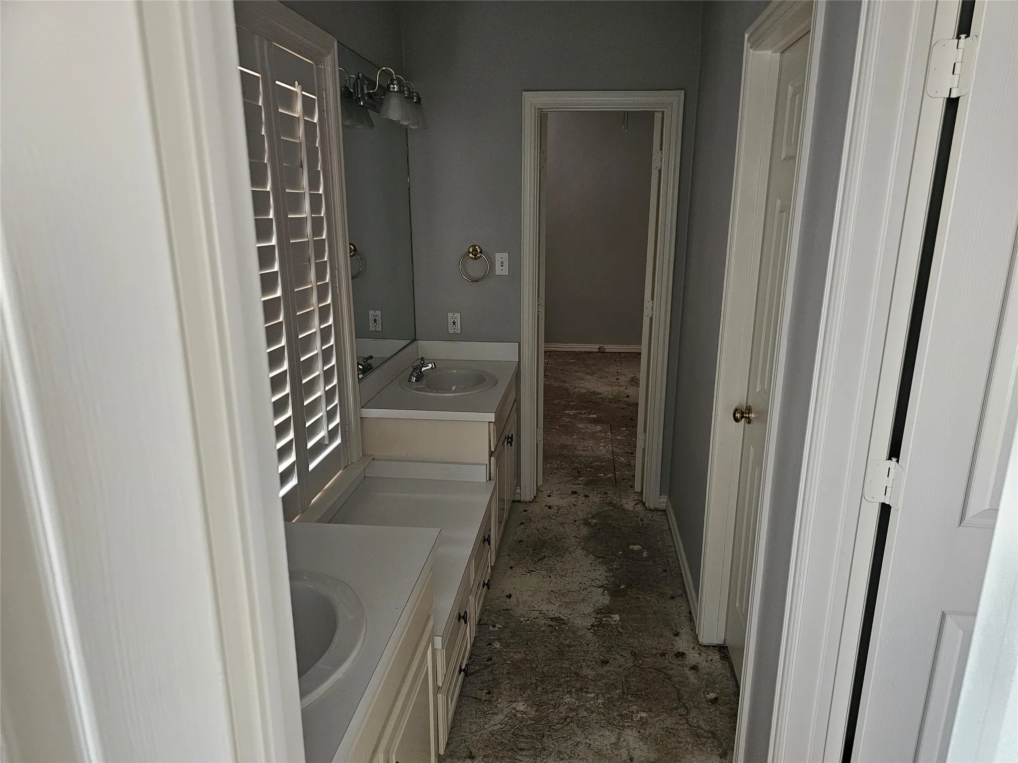 Double vanity with integrated sinks, white countertops, and white cabinetry