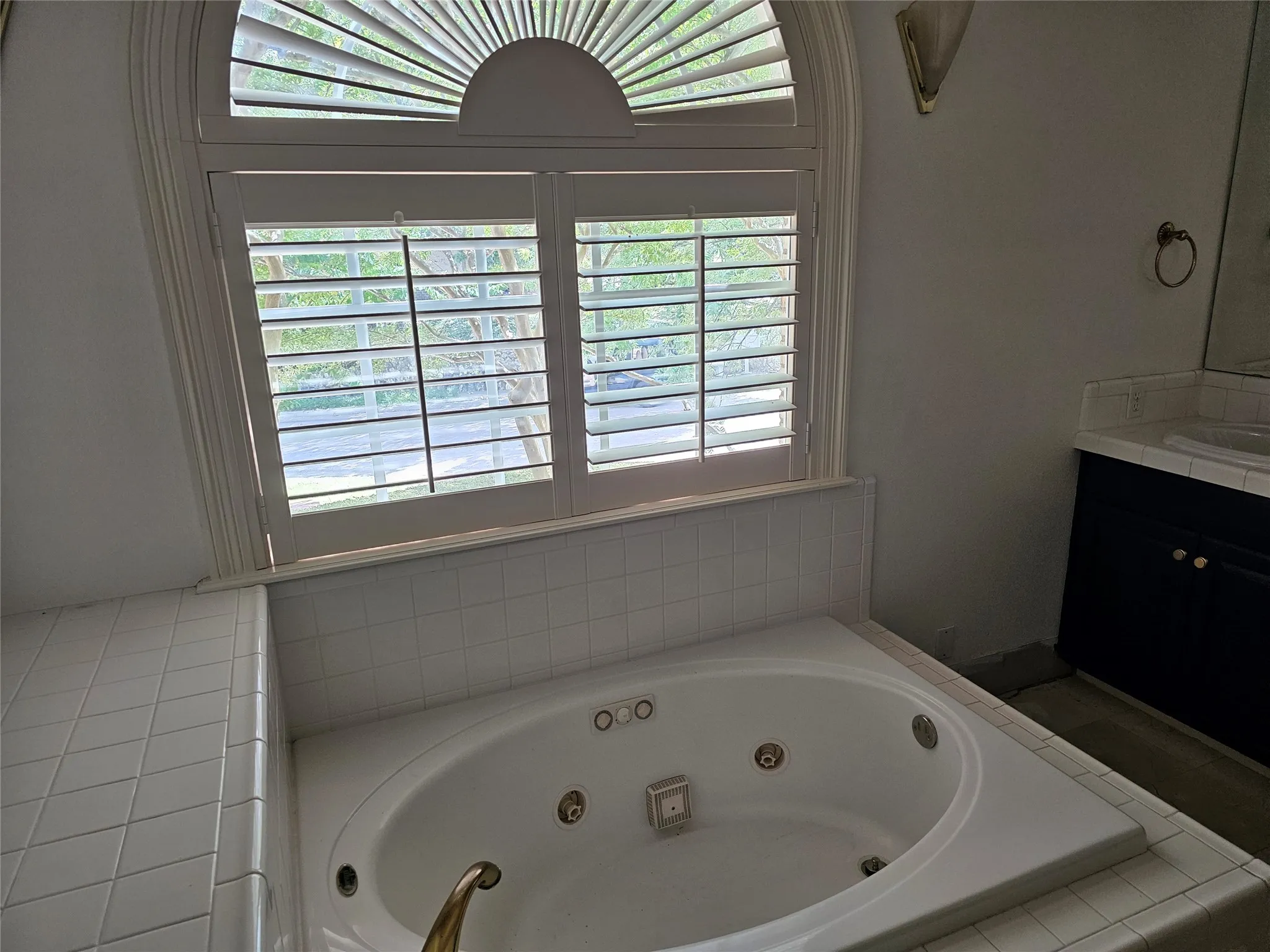 Built-in jetted tub surrounded by white tile
