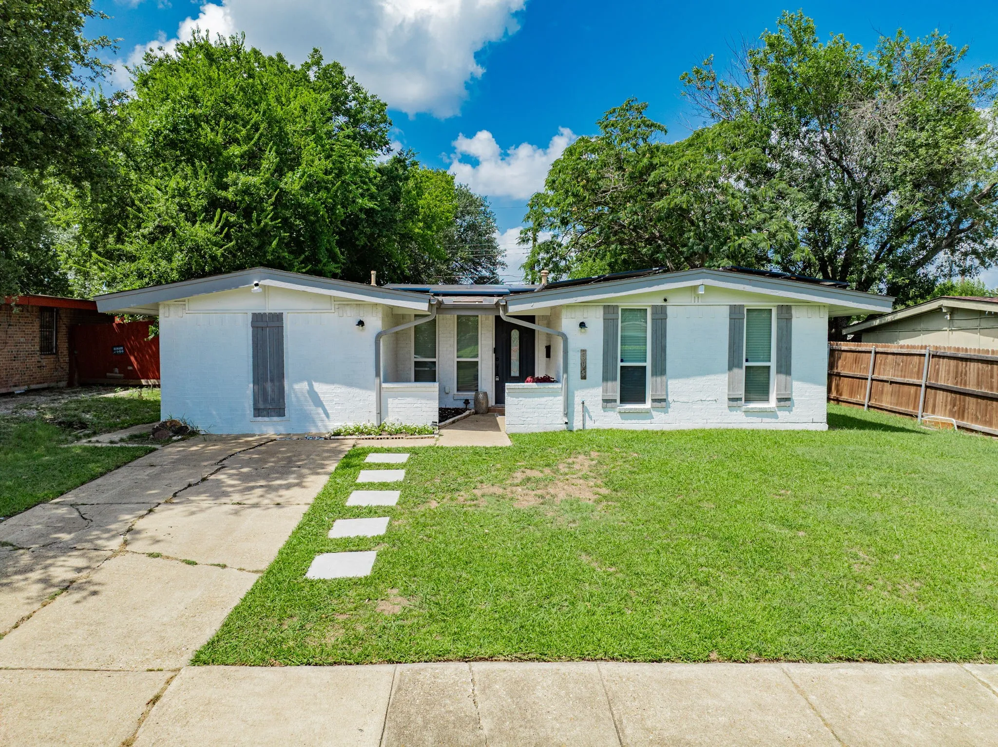 View of front facade featuring brick siding and concrete driveway