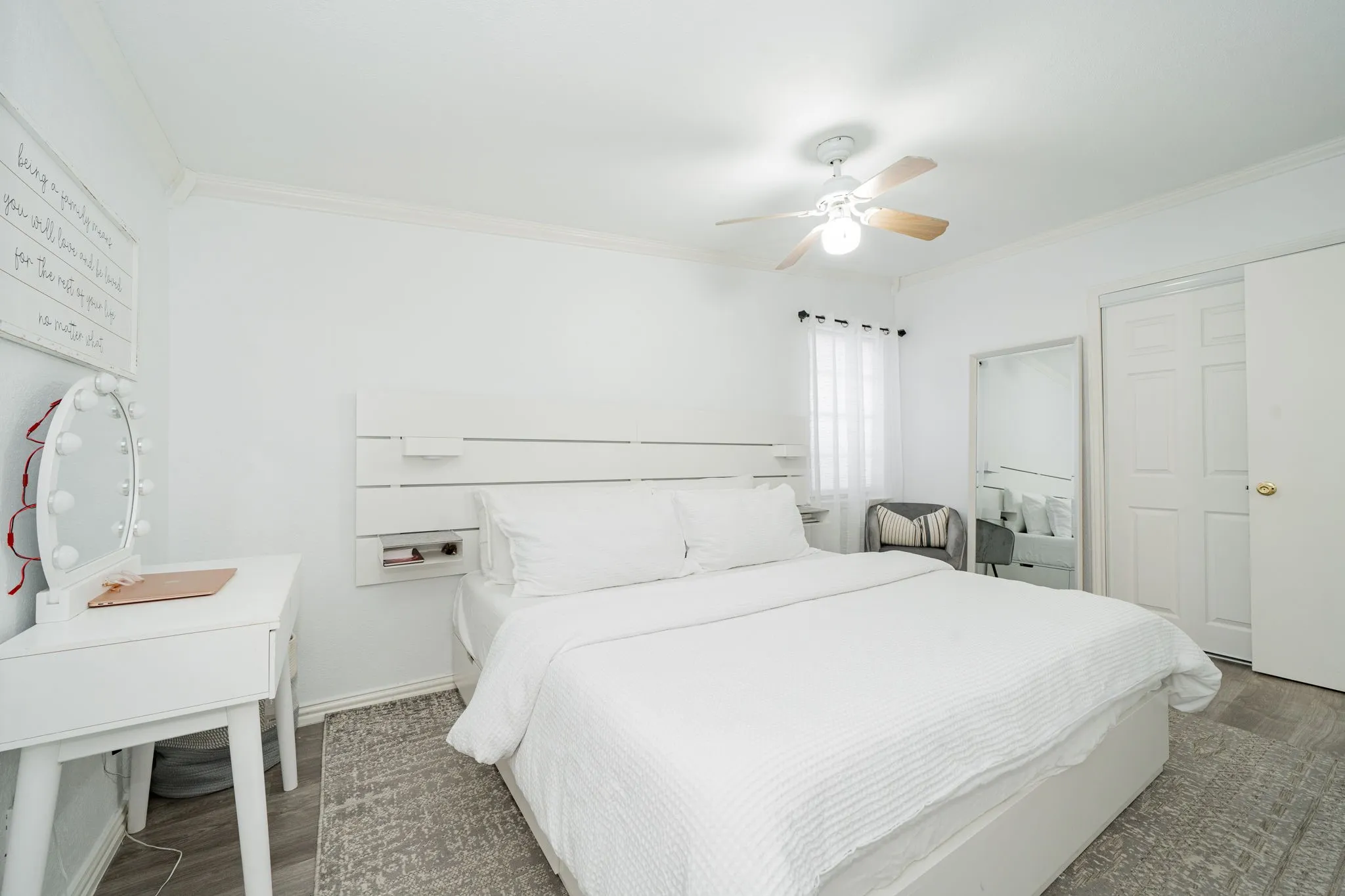 Bedroom featuring ornamental molding, wood finished floors, and a ceiling fan