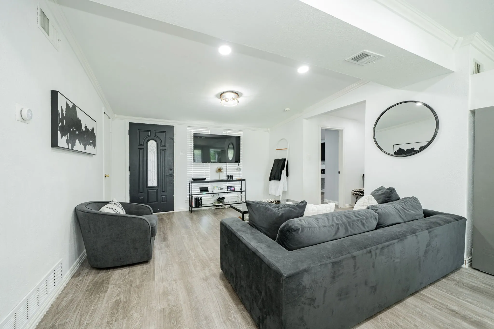 Living area with ornamental molding and light wood-type flooring