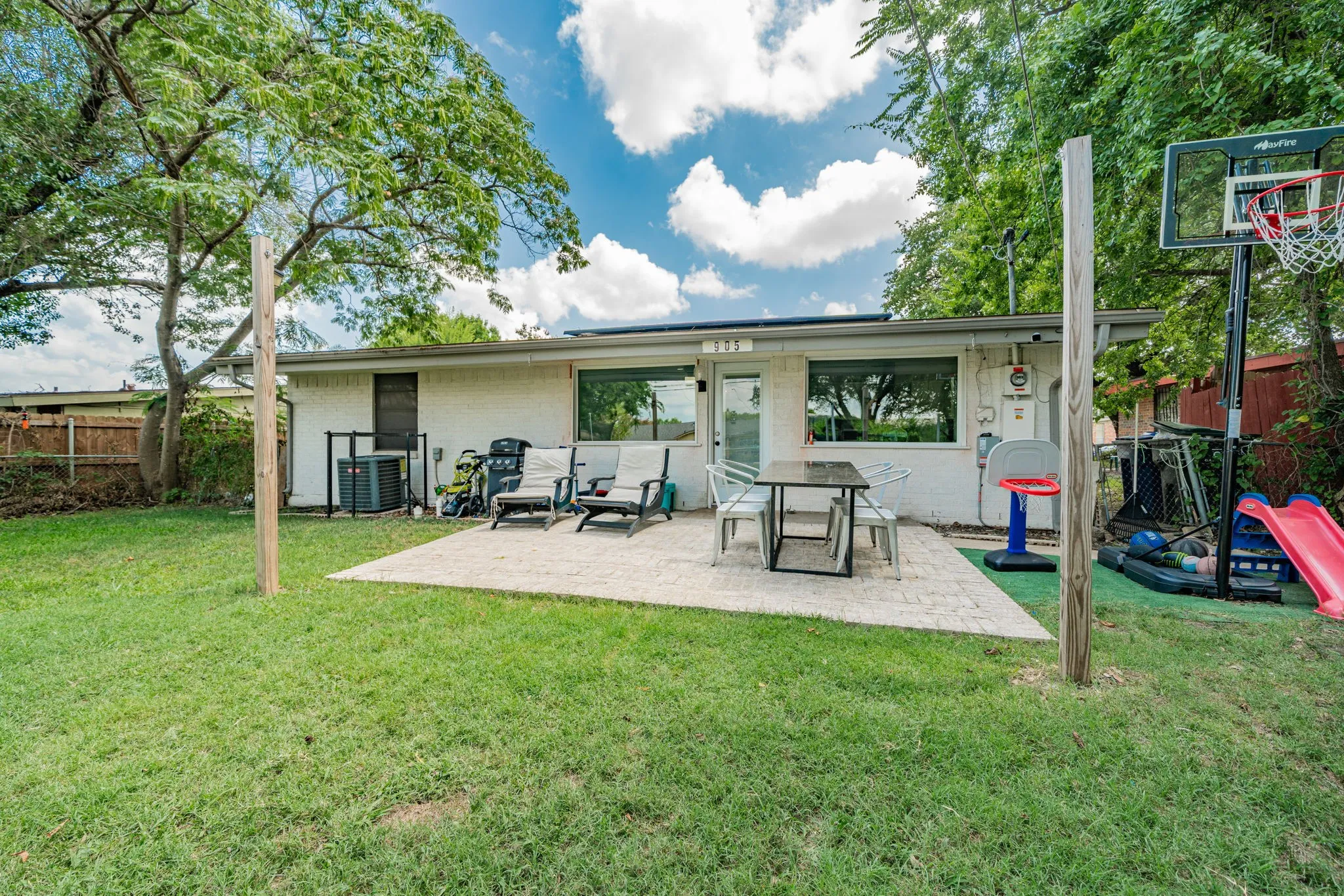 Rear view of house with a patio and brick siding