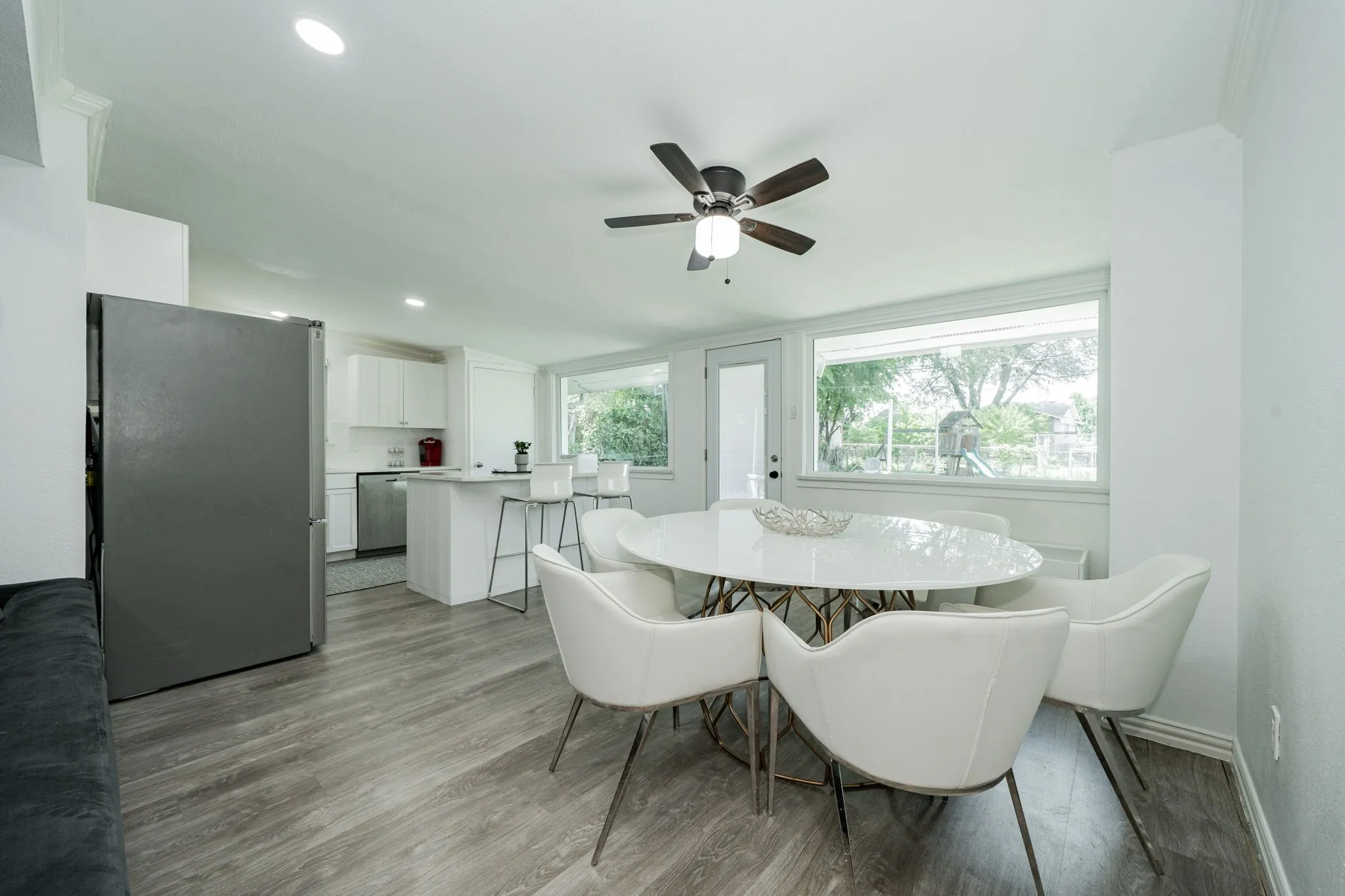 Dining space with light wood-style flooring, ceiling fan, and recessed lighting