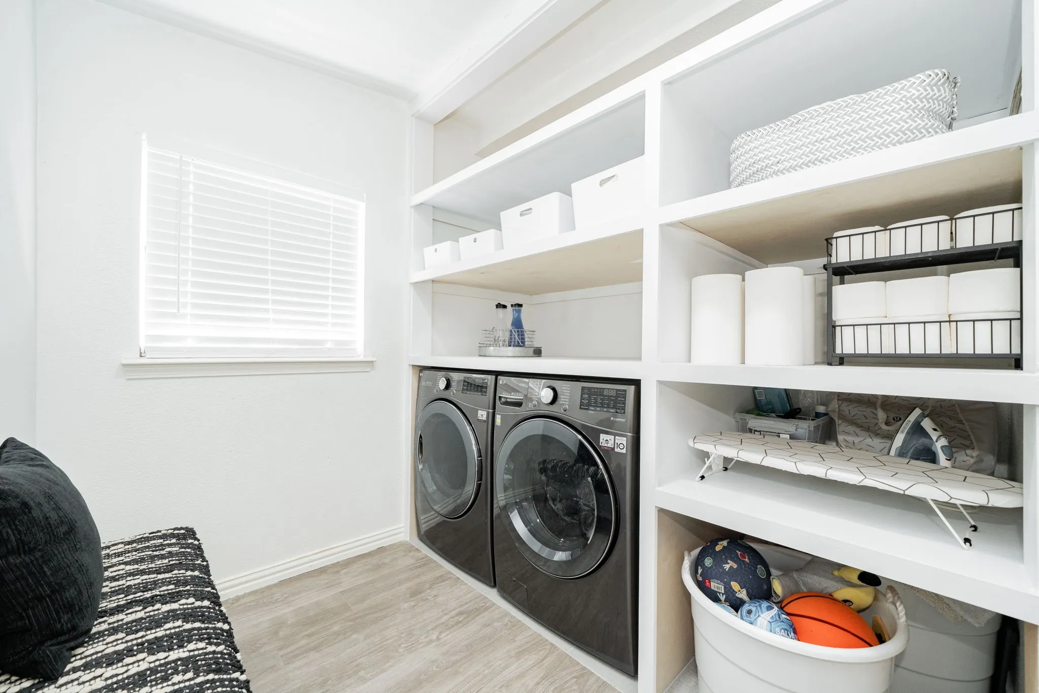 Washroom featuring independent washer and dryer and wood finished floors